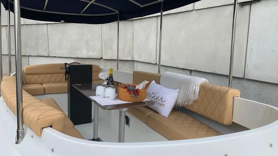 2023 Vision Marine Technologies Fantail 217 boat interior with seating and table setup.