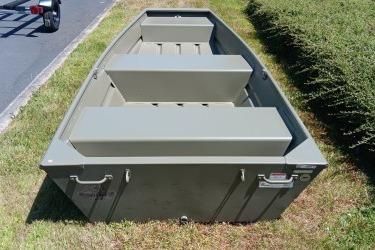 2026 Tracker Grizzly 12 Jon boat on grass, showcasing sturdy design and seating.