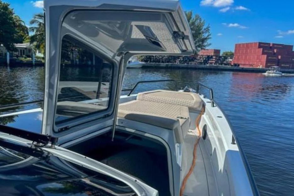 2023 BRABUS Shadow 900 ST boat on a sunny waterfront, open cabin view.
