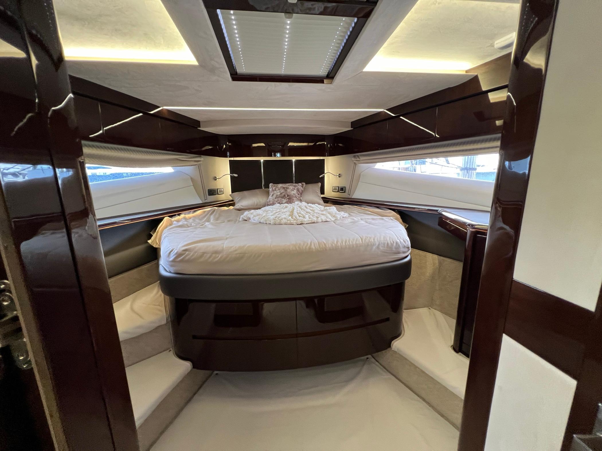Luxurious bedroom interior of 2020 Galeon 680 Fly yacht with modern design and ambient lighting.