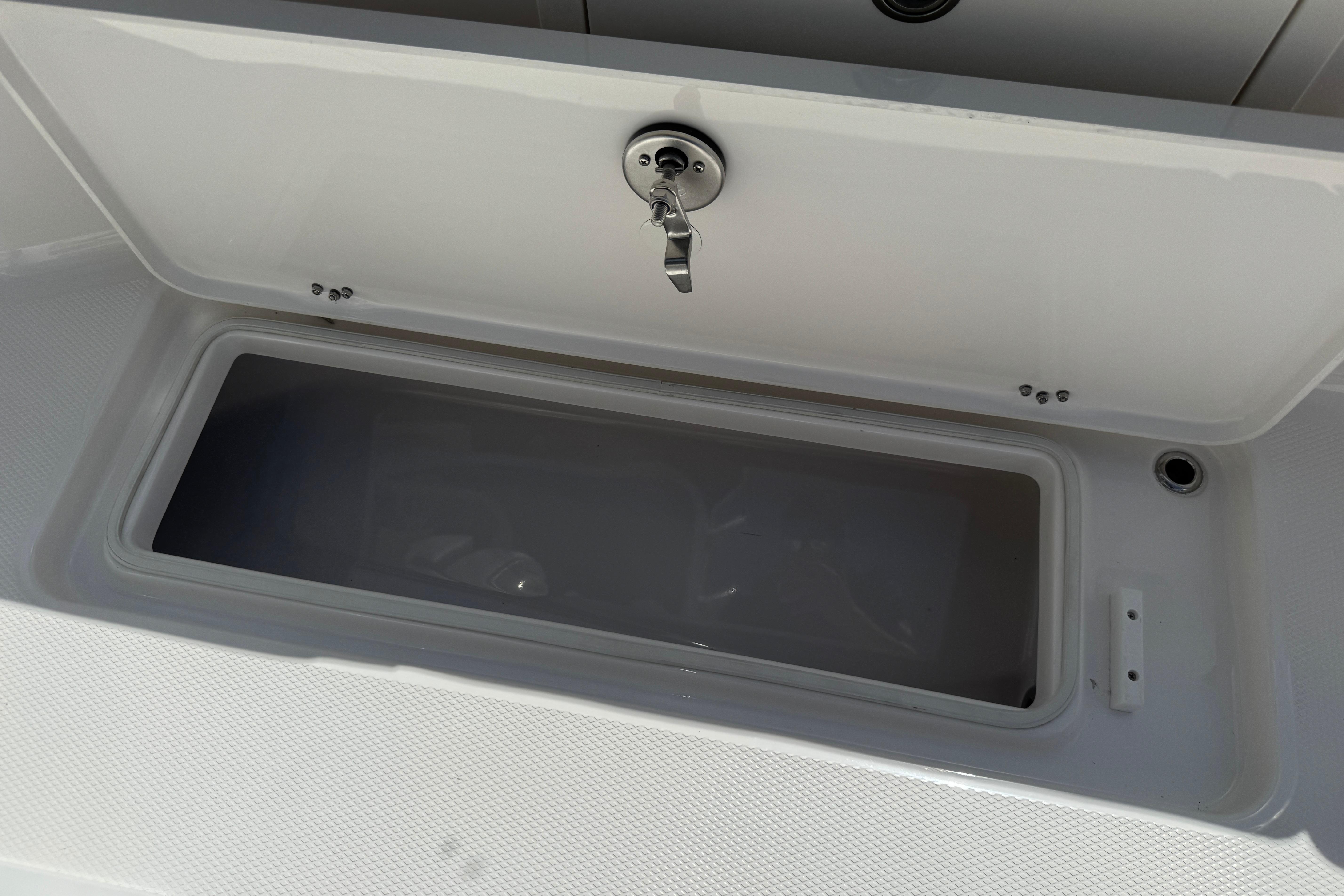 Open storage compartment on 2026 Robalo R250 Center Console boat.