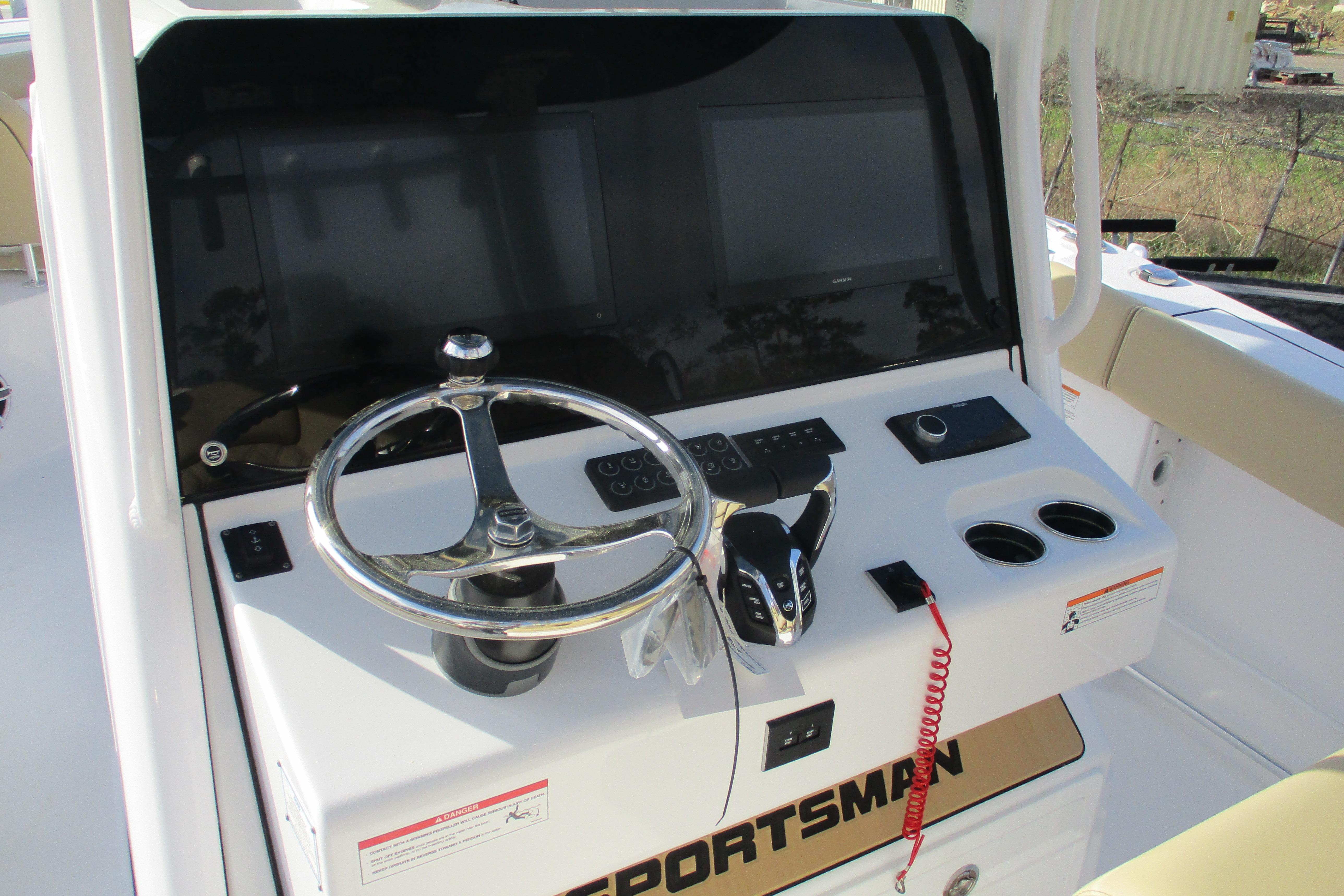 2026 Sportsman Open 302 Center Console helm with steering wheel and controls.