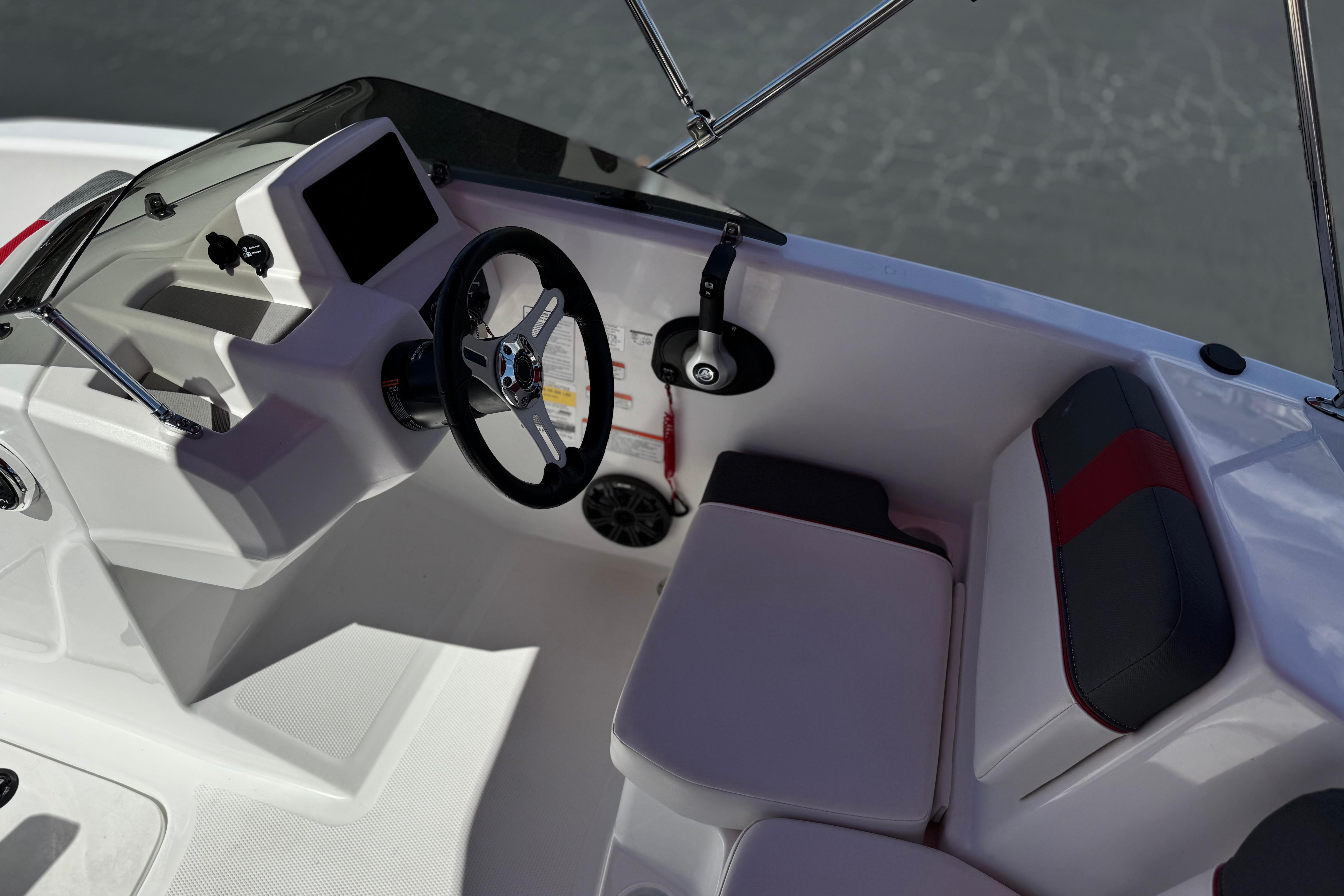 2024 Tahoe T16 boat interior with steering wheel and seating, showcasing modern design.