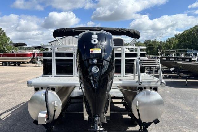 2026 Sun Tracker Fishin' Barge 22 DLX pontoon boat with powerful outboard motor.