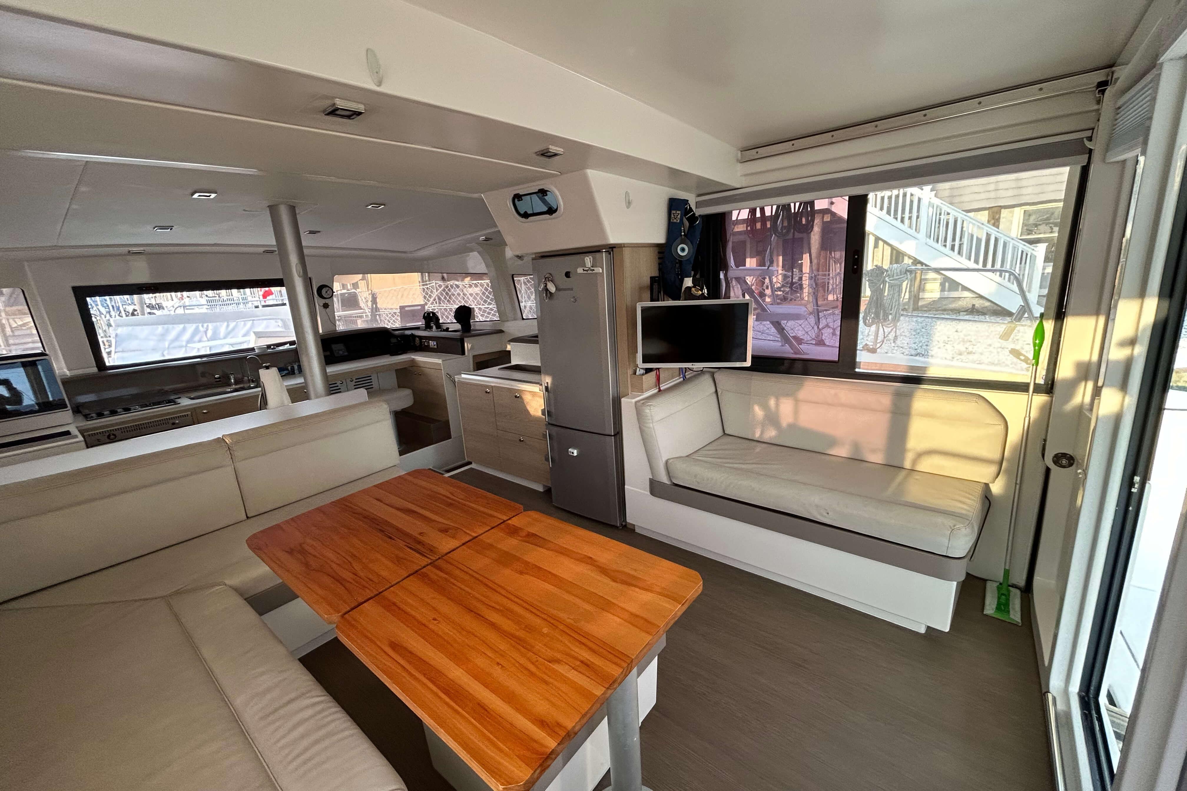 Interior of 2018 Bali 4.1 catamaran with modern seating and wooden table.