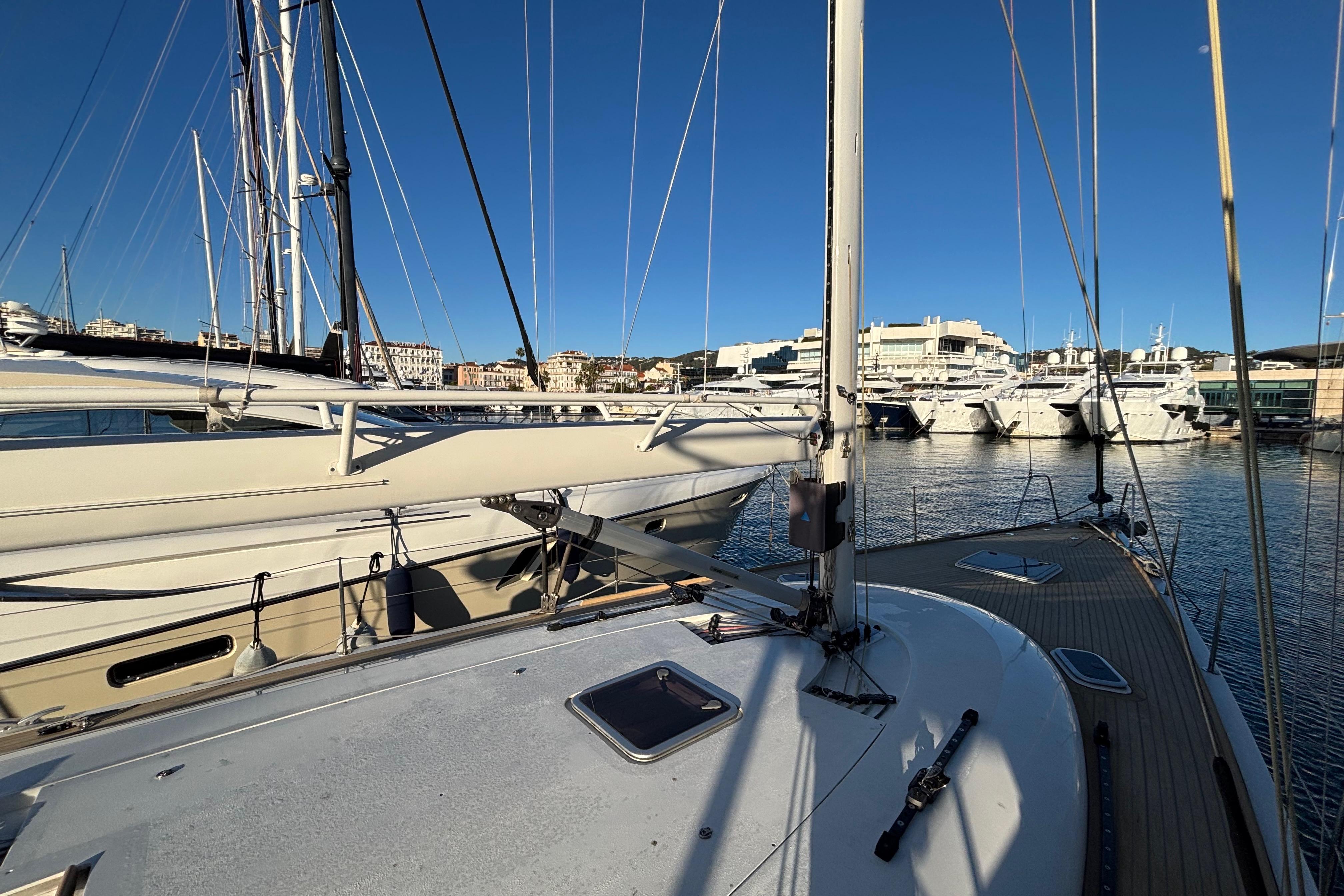 Sailboat deck view in marina, featuring 2008 Fauroux 50, with yachts and buildings in background.