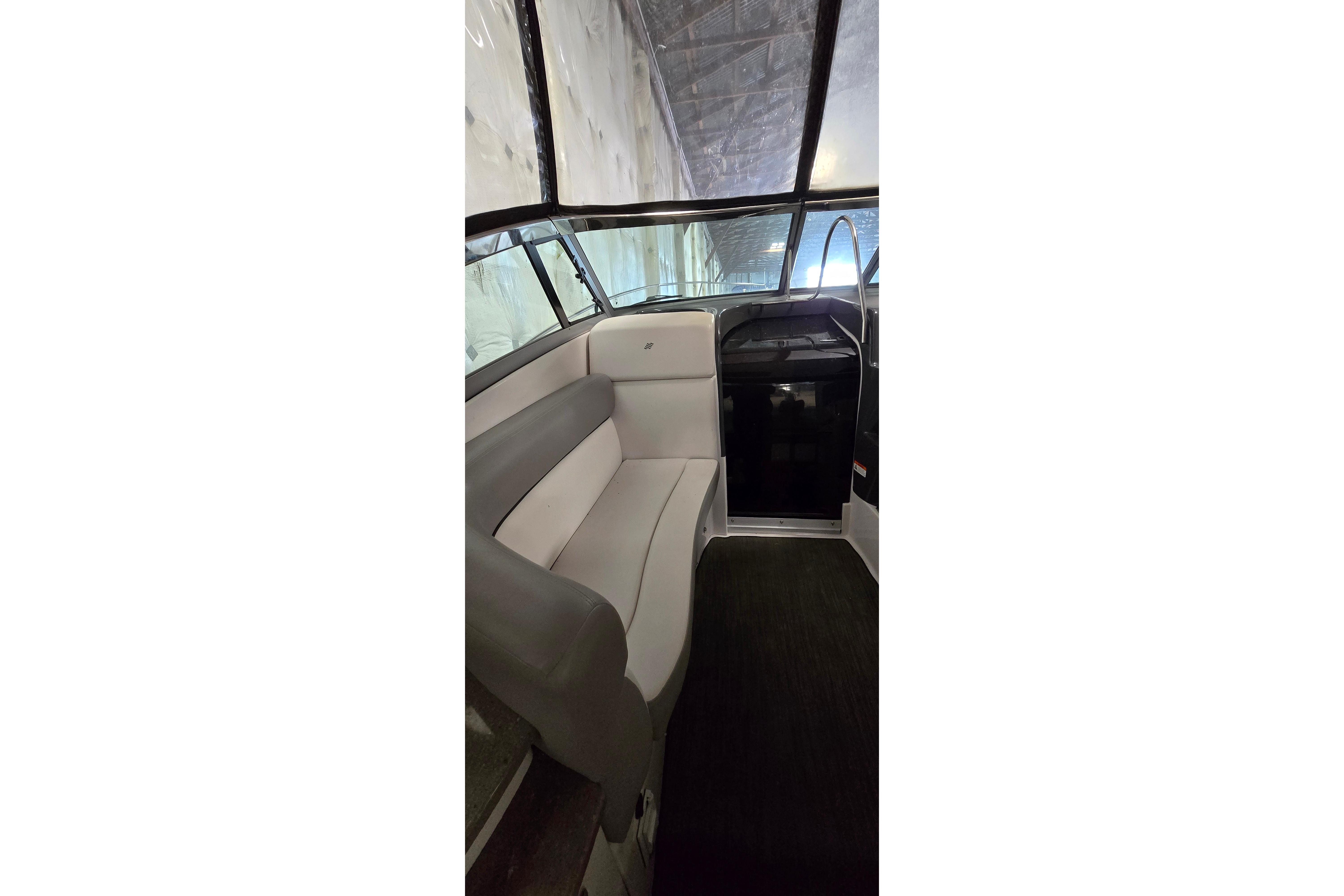 Interior view of 2018 Four Winns V355 boat, featuring comfortable seating and sleek design.