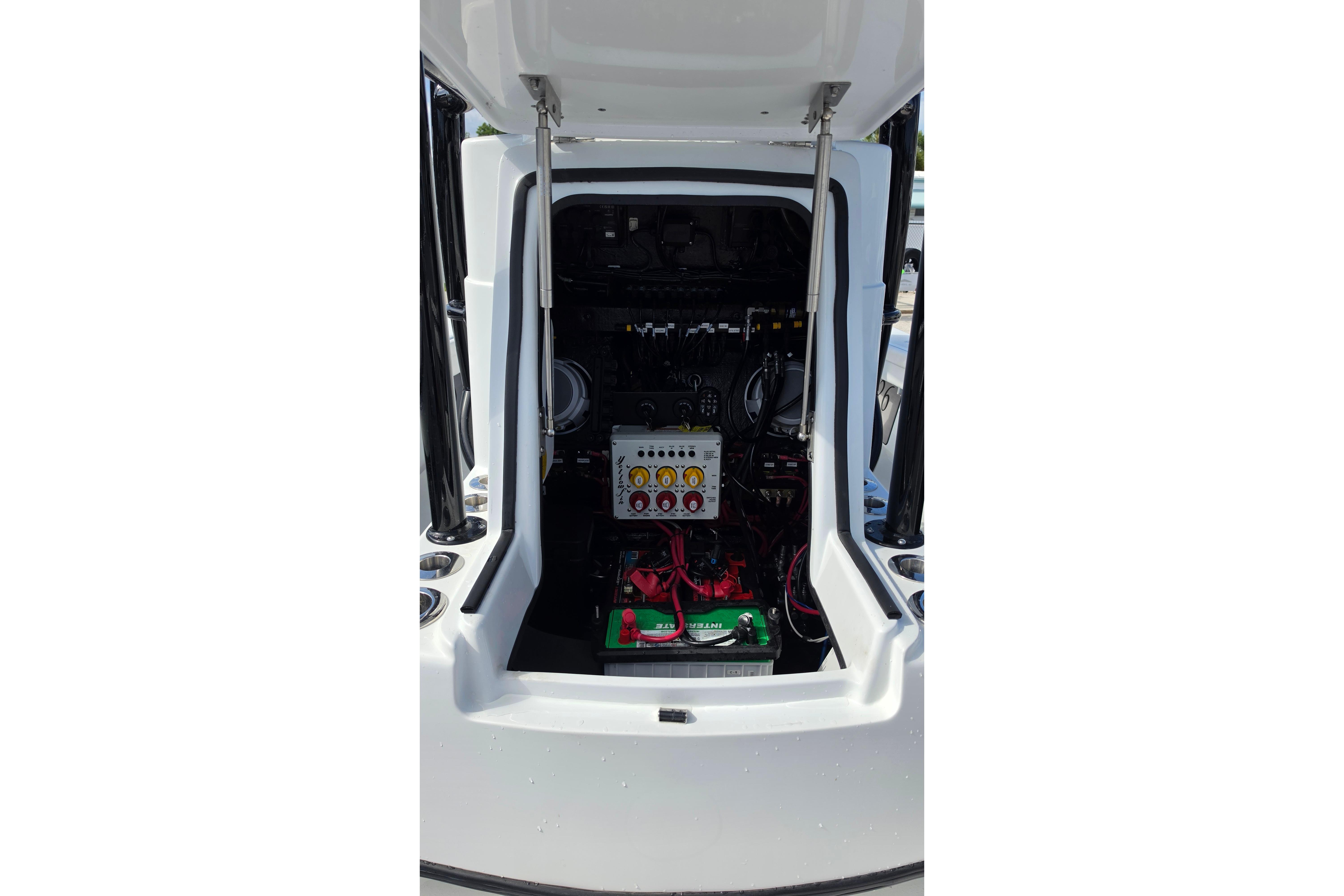2025 Yellowfin 26 Hybrid boat engine compartment with visible wiring and components.