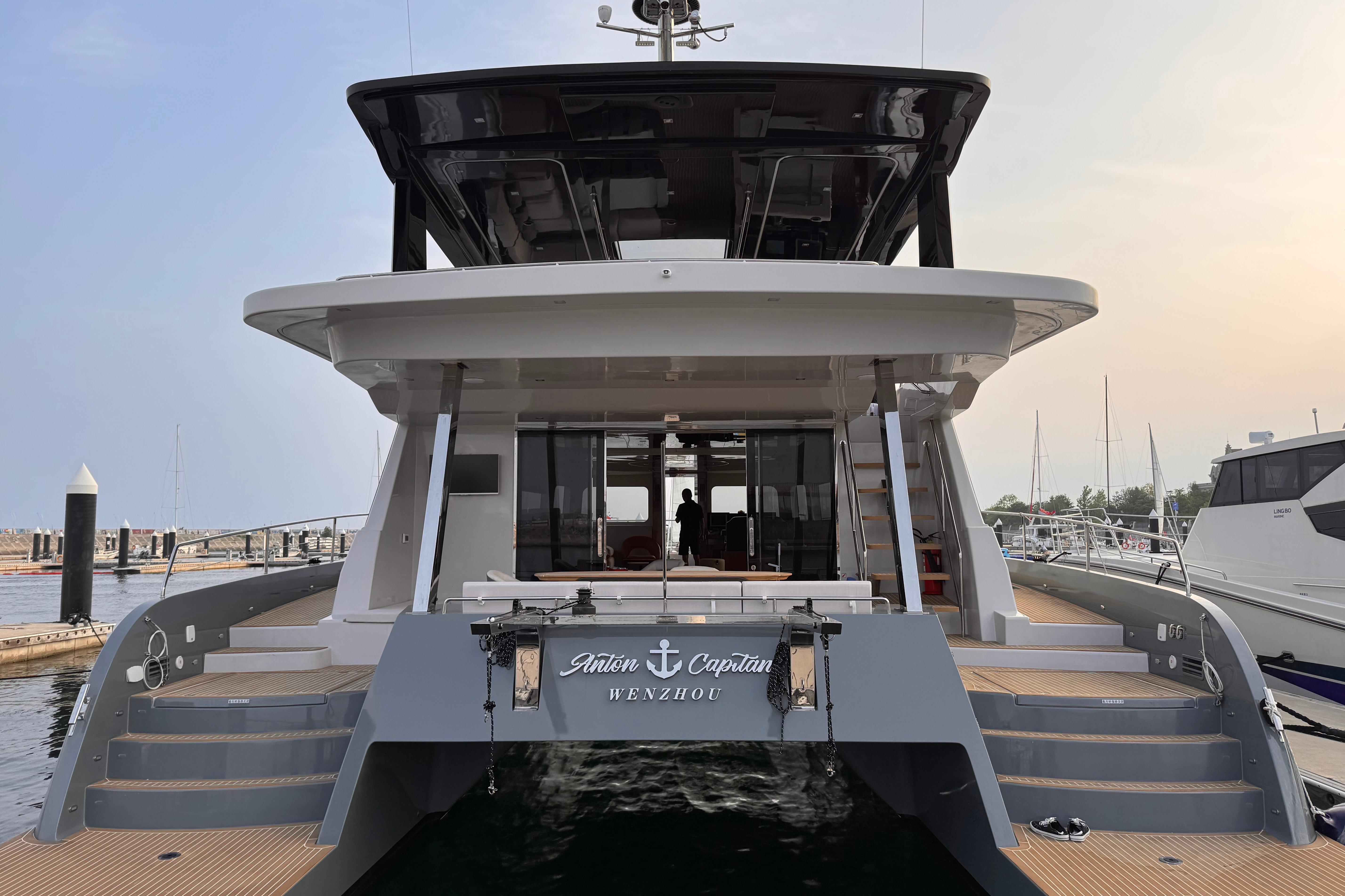 2025 Mazarin 55 Catamaran Hybrid Electric EVO II docked at marina, rear view.