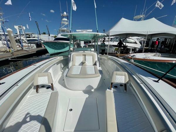 2025 Mag Bay 43 Center Console boat at a marina, showcasing spacious seating and modern design.