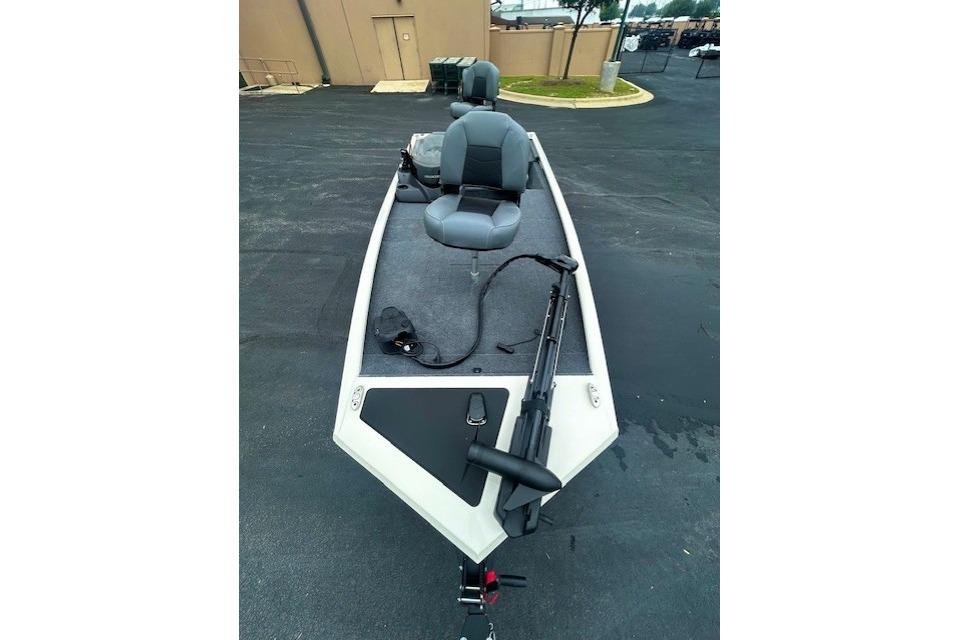 2026 Tracker Pro 170 boat with seating and fishing equipment on a paved surface.