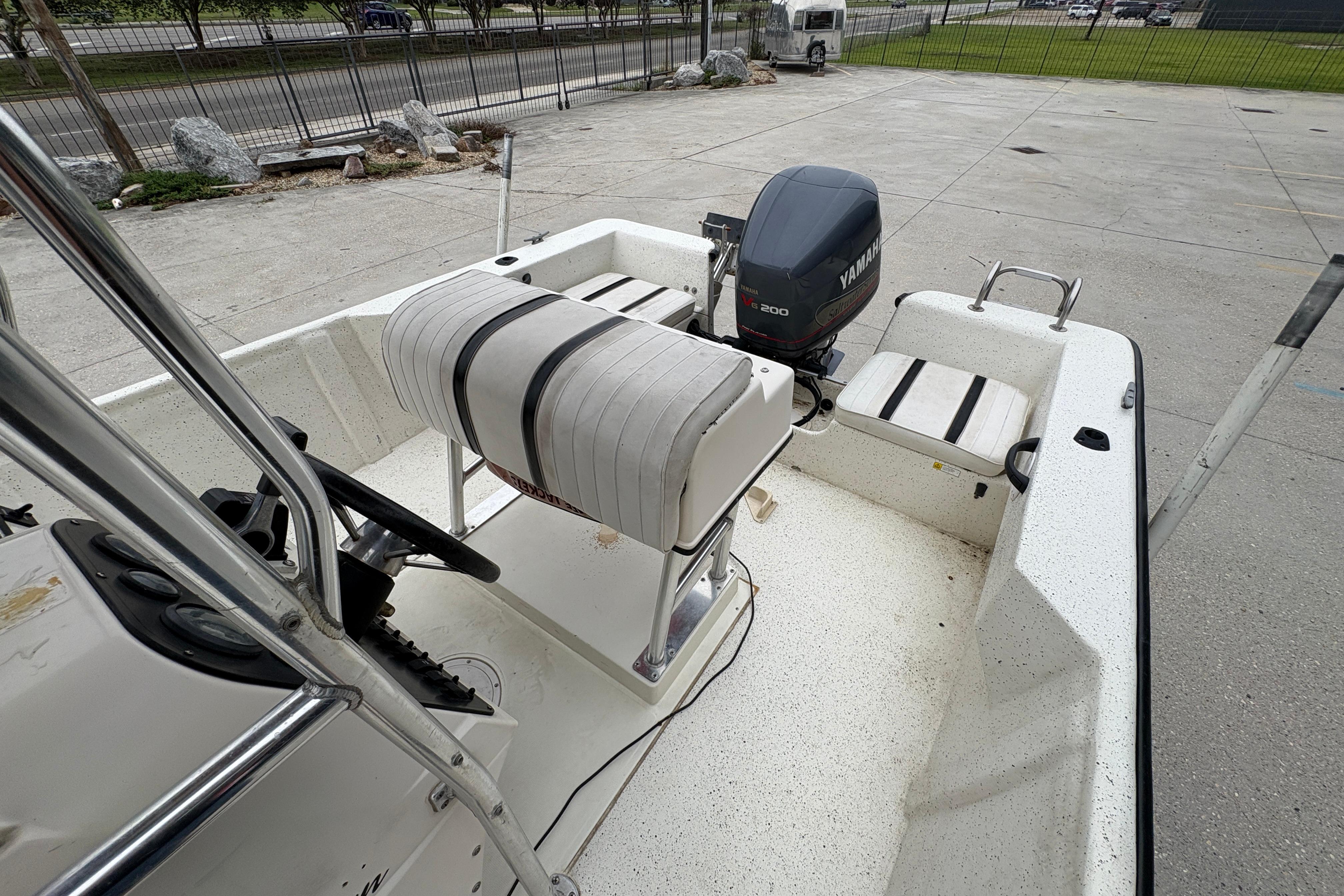 1998 Hydra-Sports 22 Ocean CC boat interior with Yamaha engine, parked outdoors.