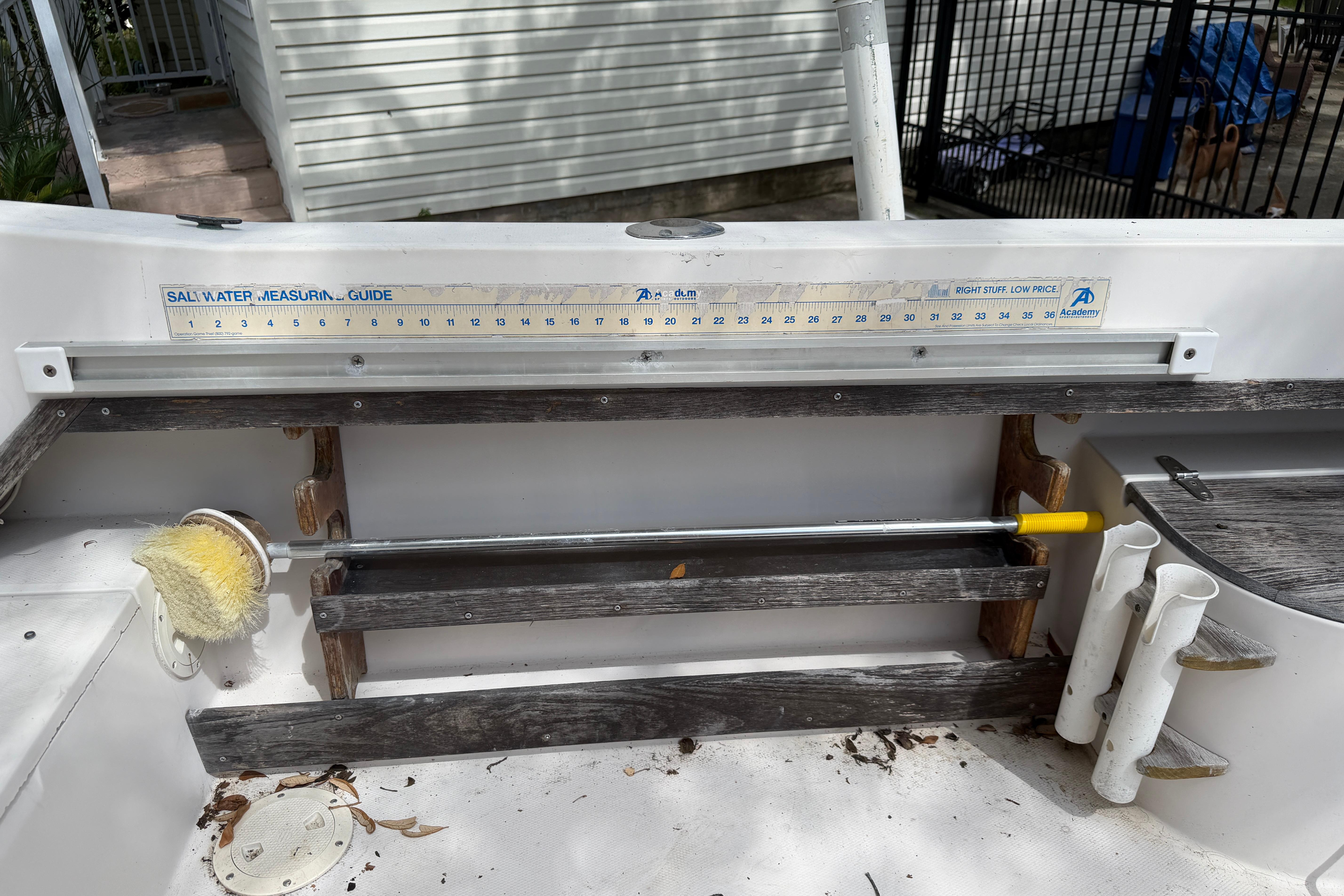 1987 Grady-White Seafarer 226 boat interior with saltwater measuring guide and cleaning brush.