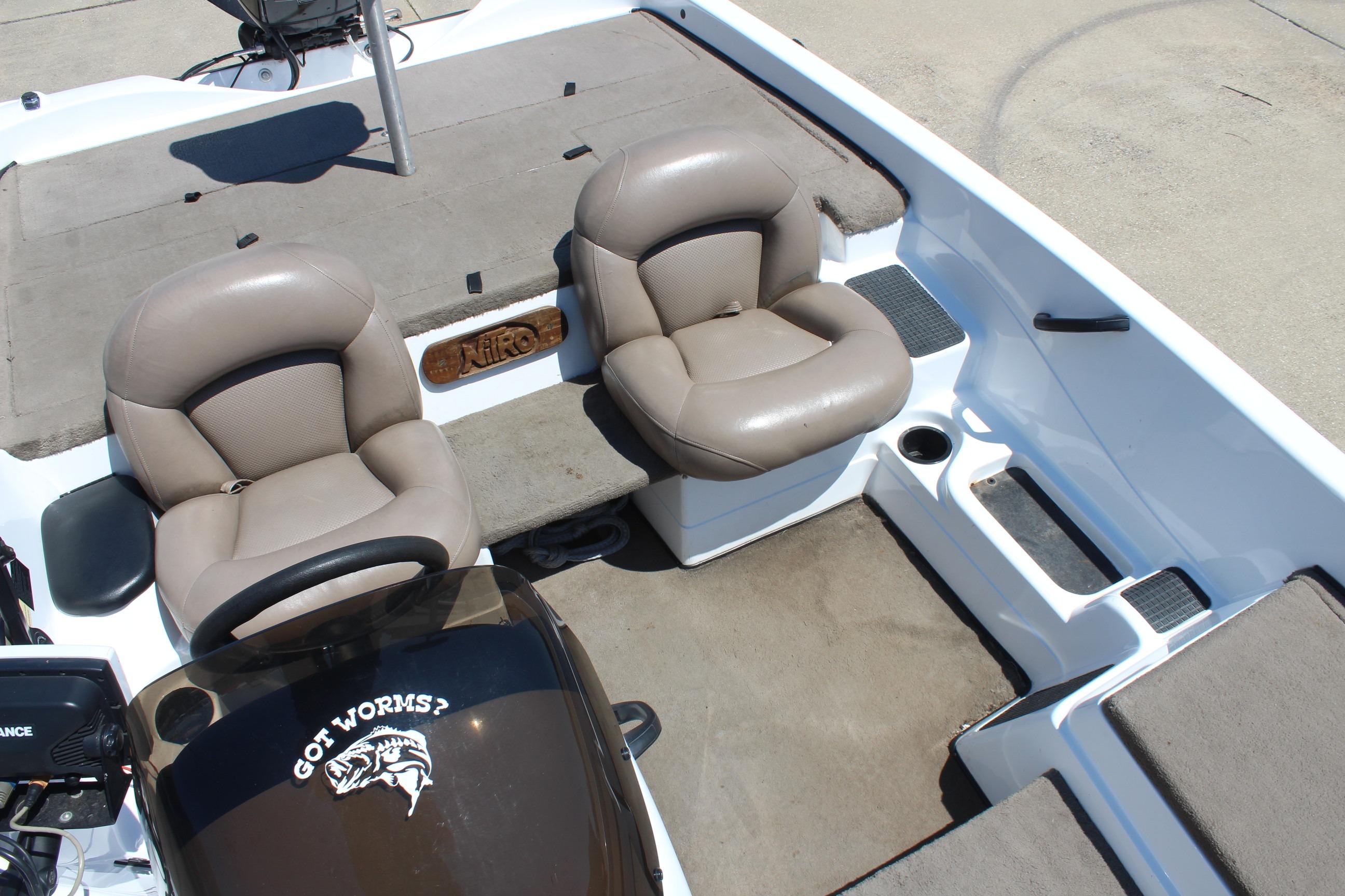 2003 Nitro NX 750 SC boat interior with two beige seats and steering console.