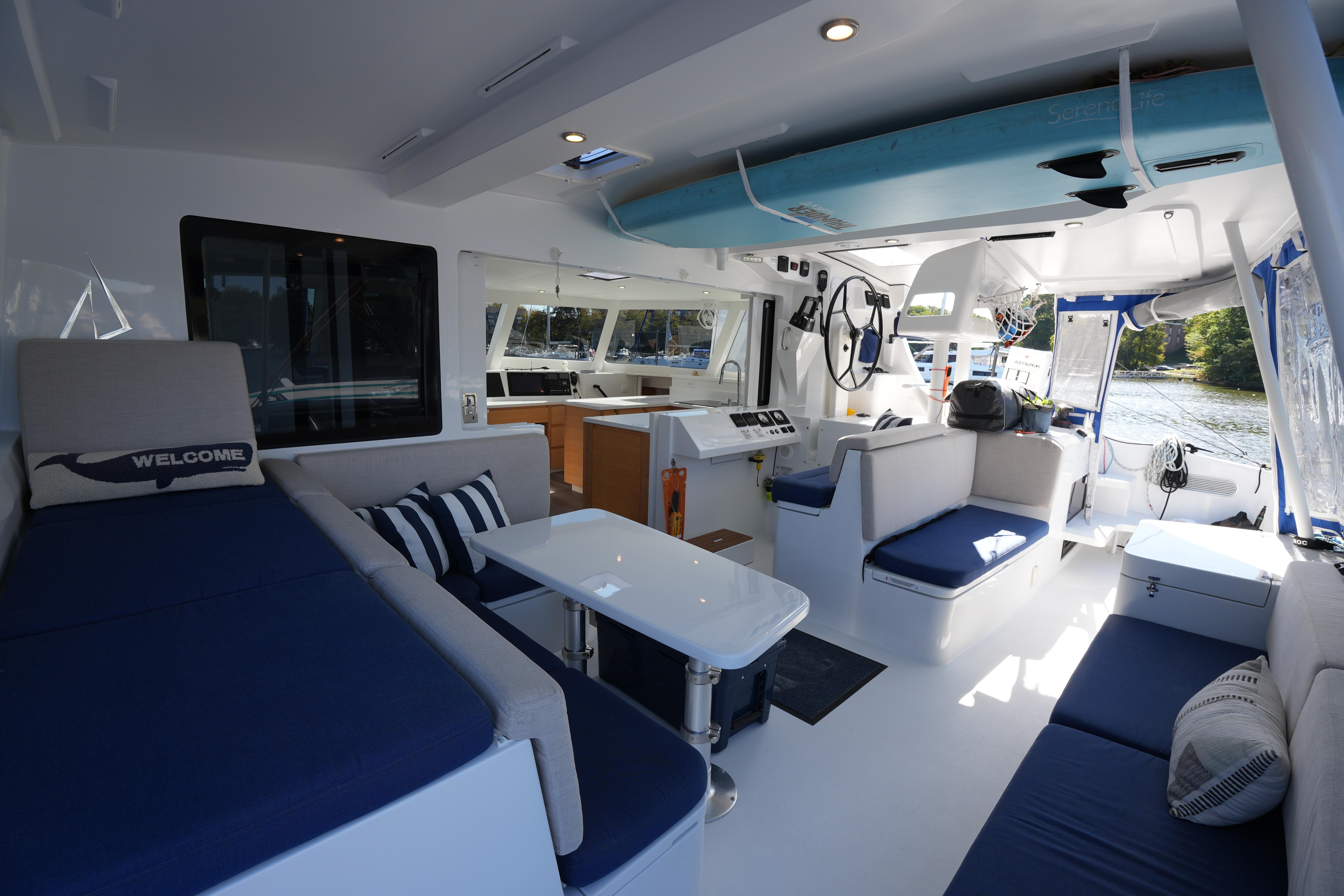 Luxurious interior of 2024 Balance 442 catamaran with modern seating and navigation area.