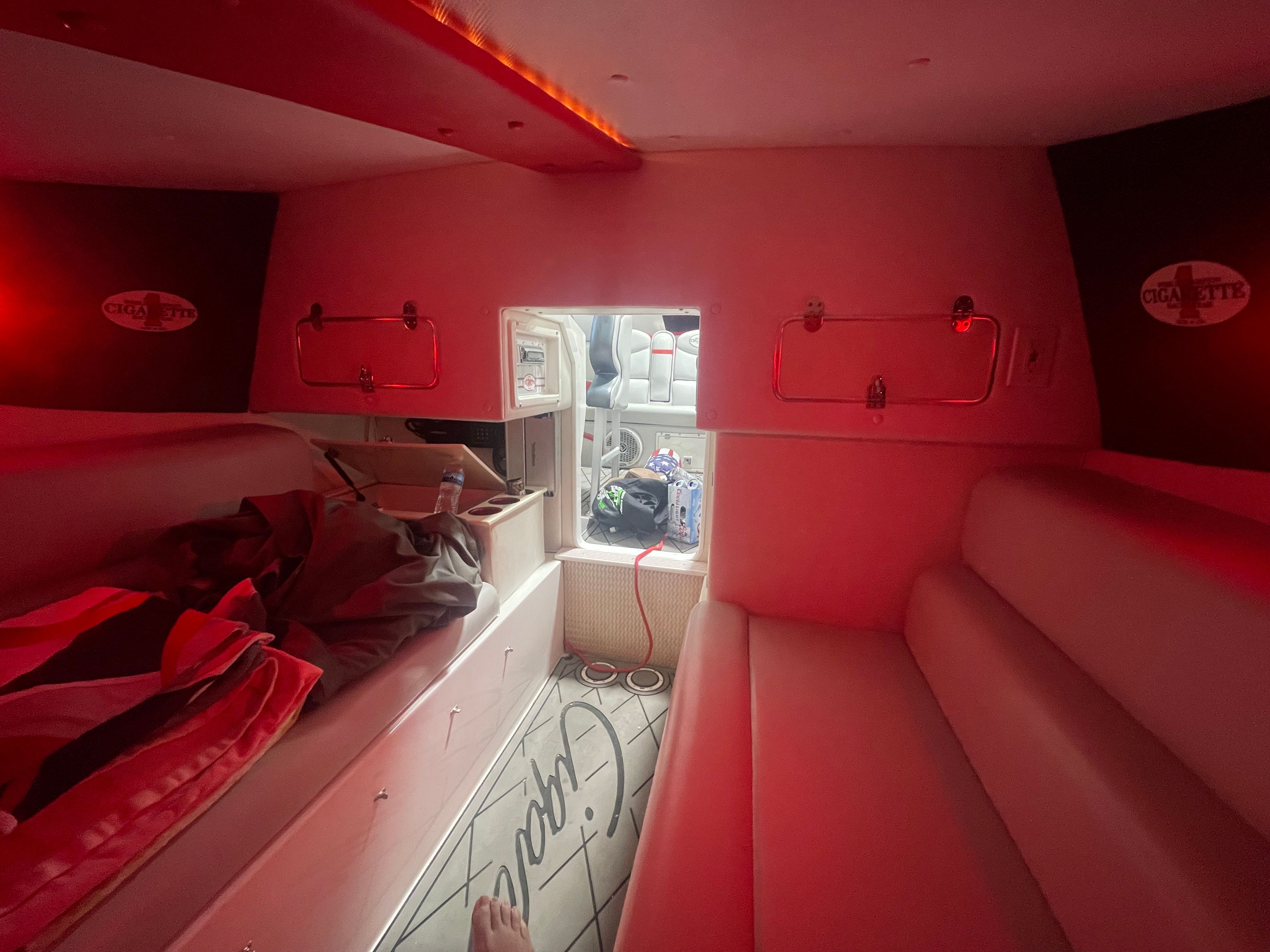 Interior of a 2004 Cigarette 38' Top Gun boat with red lighting.
