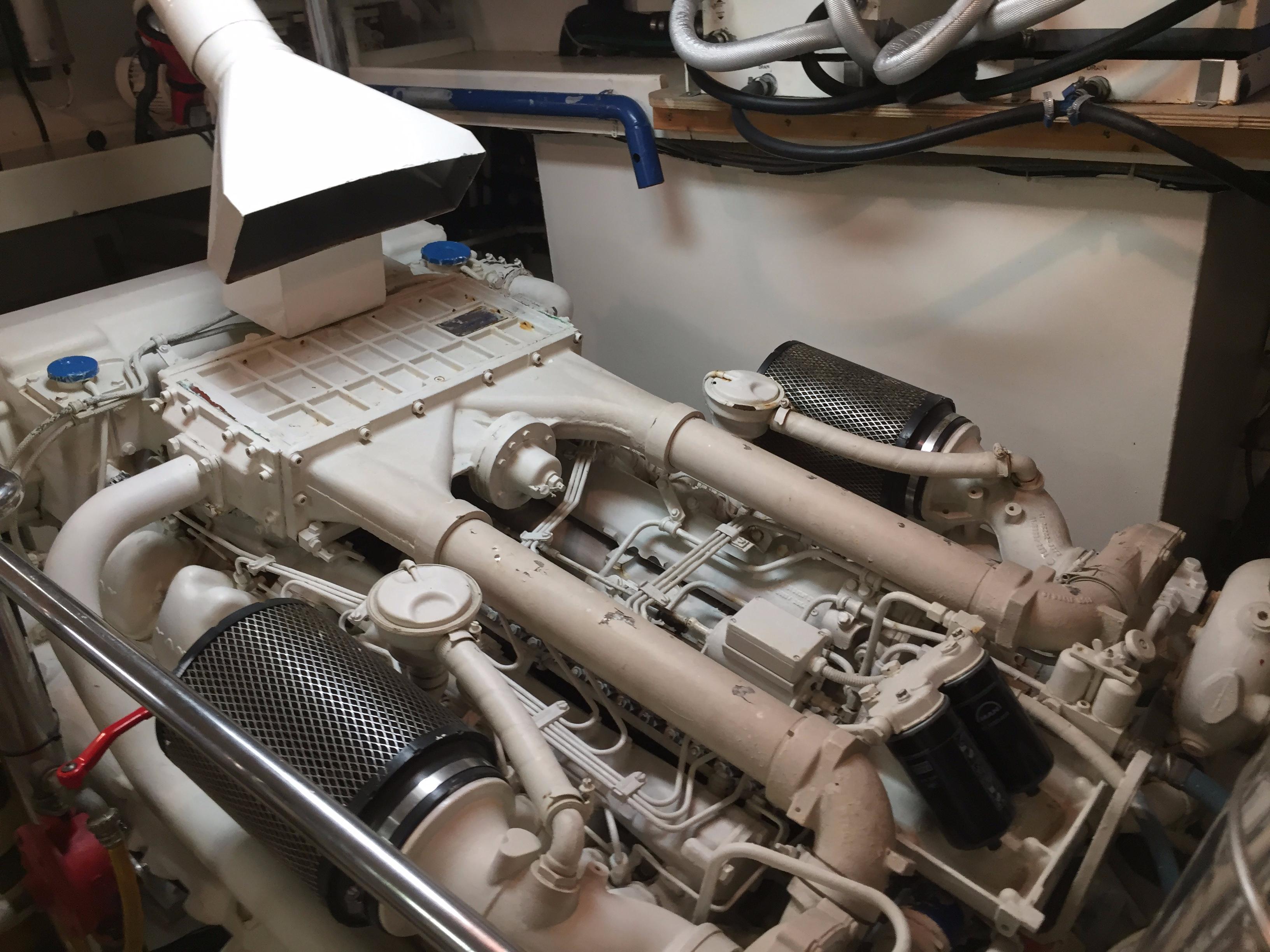 Engine room of a 1994 Falcon 76 yacht, showcasing complex machinery and components.