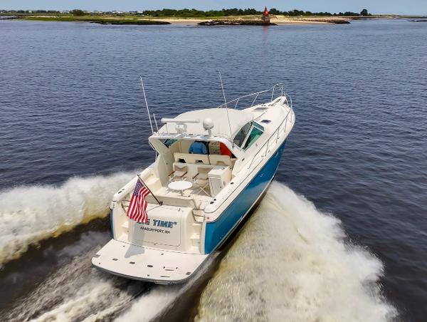 1996 Tiara Yachts 3500 Express cruising on water, rear view.