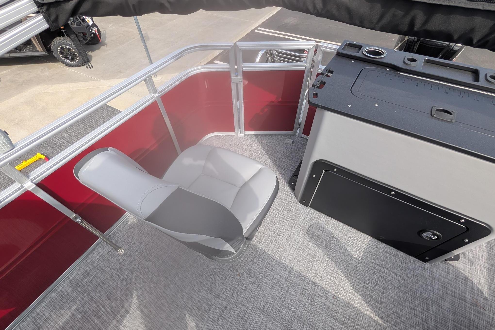 2026 Sun Tracker SportFish 20 DLX boat interior with gray seating and control panel.