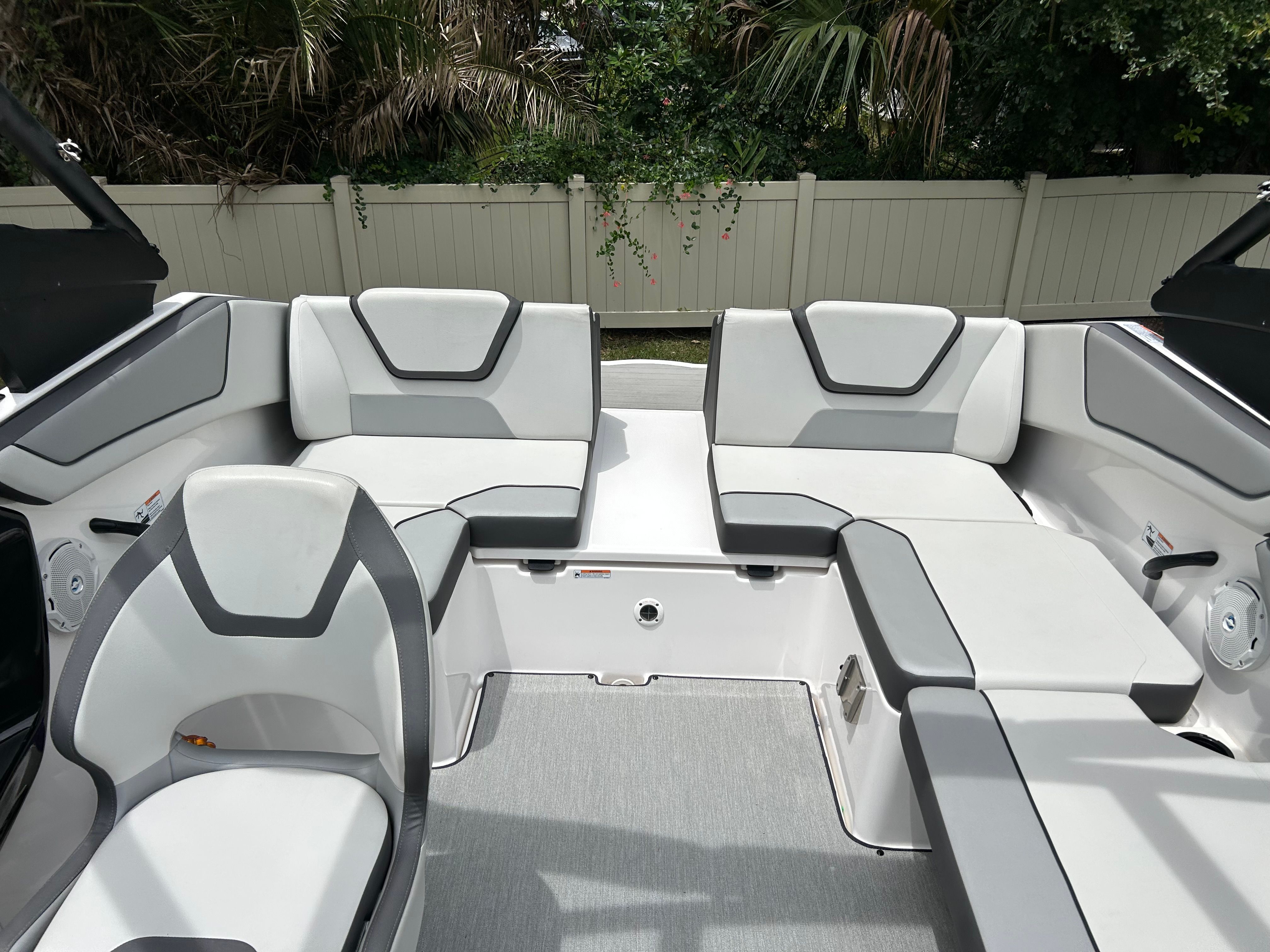 Interior of a modern boat with gray and white seating.