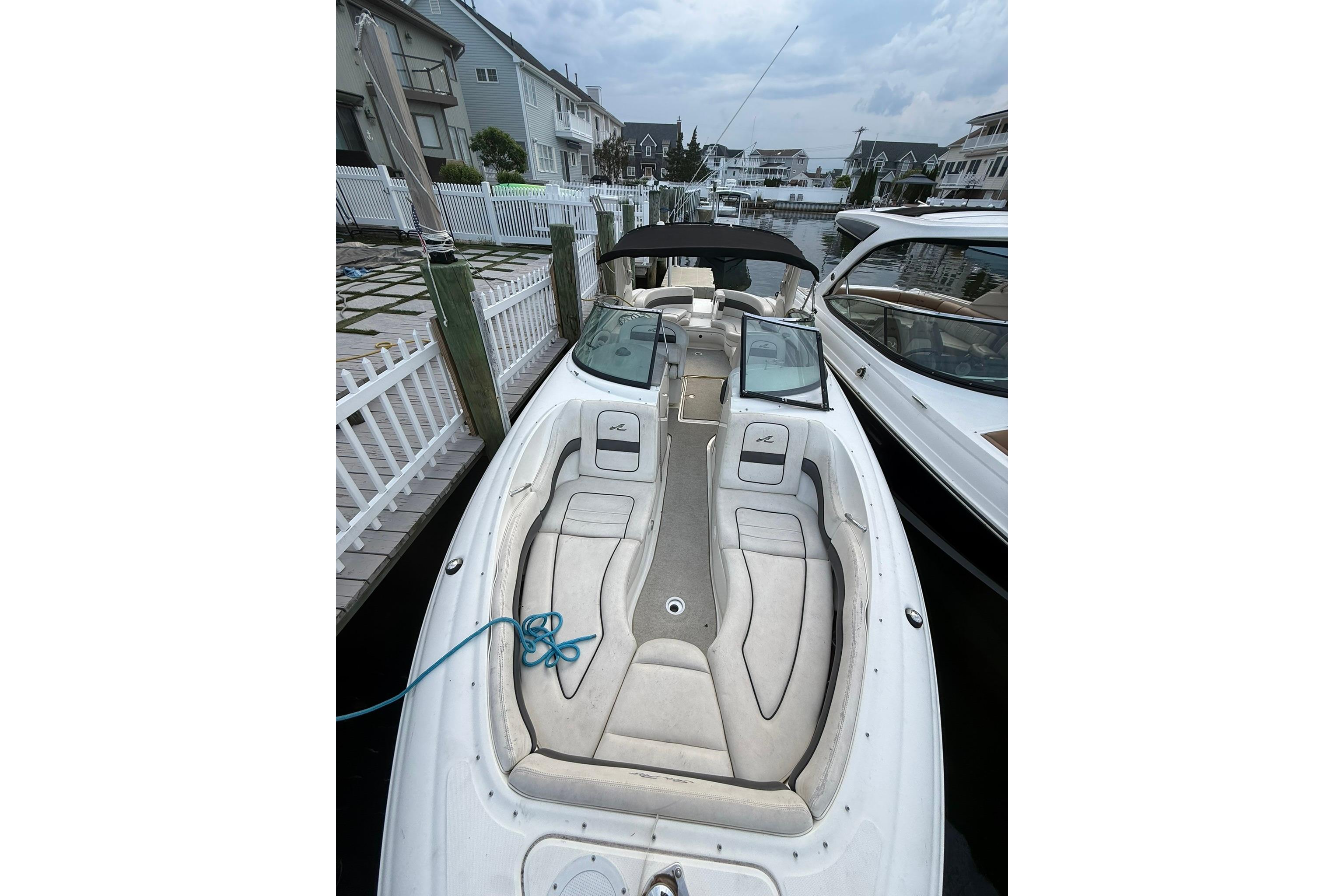 2005 Sea Ray 290 SLX boat docked, featuring spacious seating and sleek design.