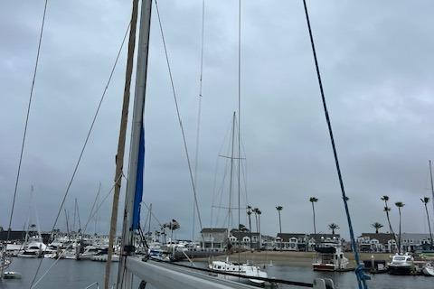 Sailboats docked in a marina under cloudy skies, featuring a Bavaria 42 Cruiser, 2000 model.