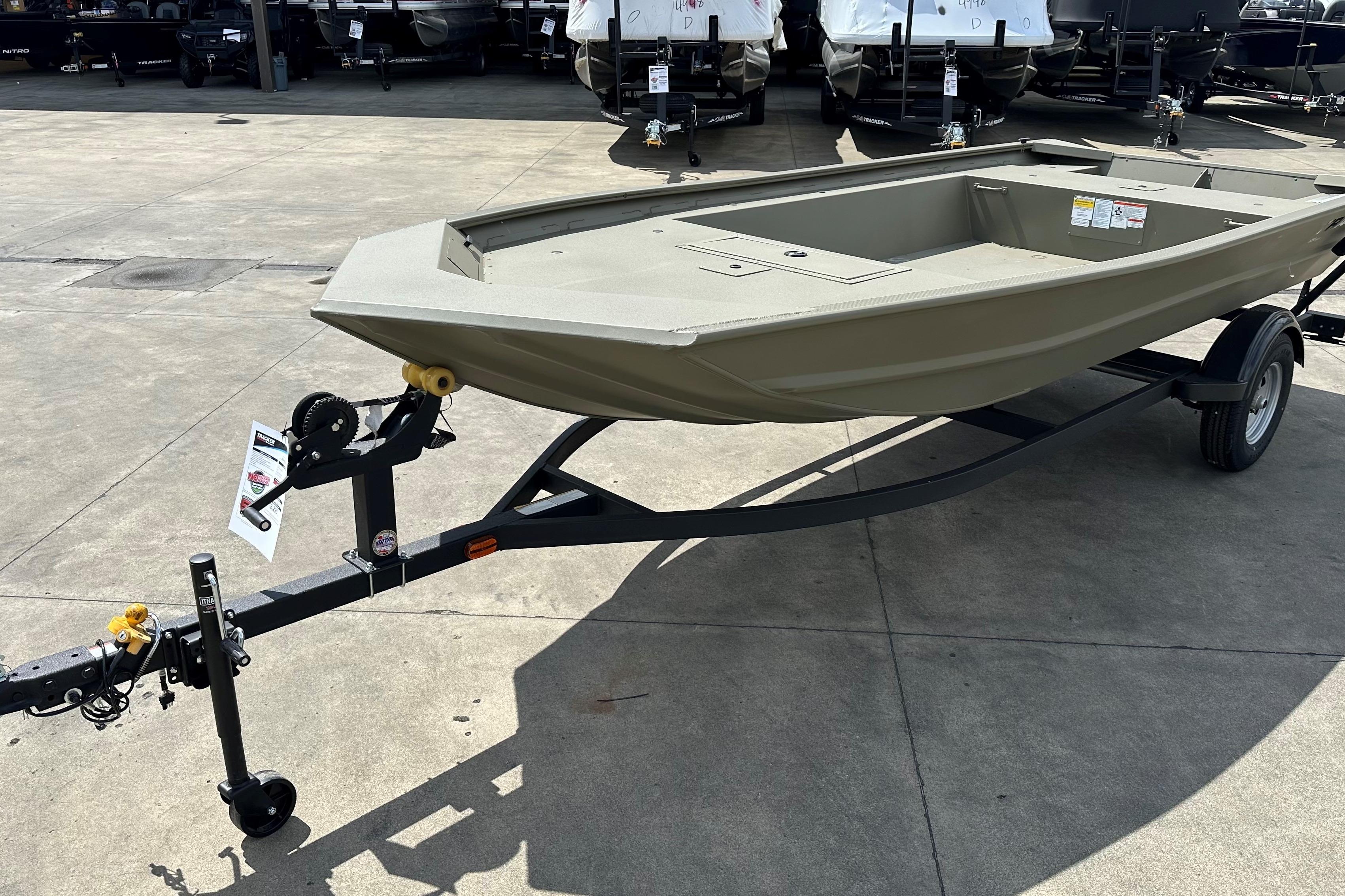 2026 Tracker Grizzly 1754 Utility boat on trailer in outdoor showroom.
