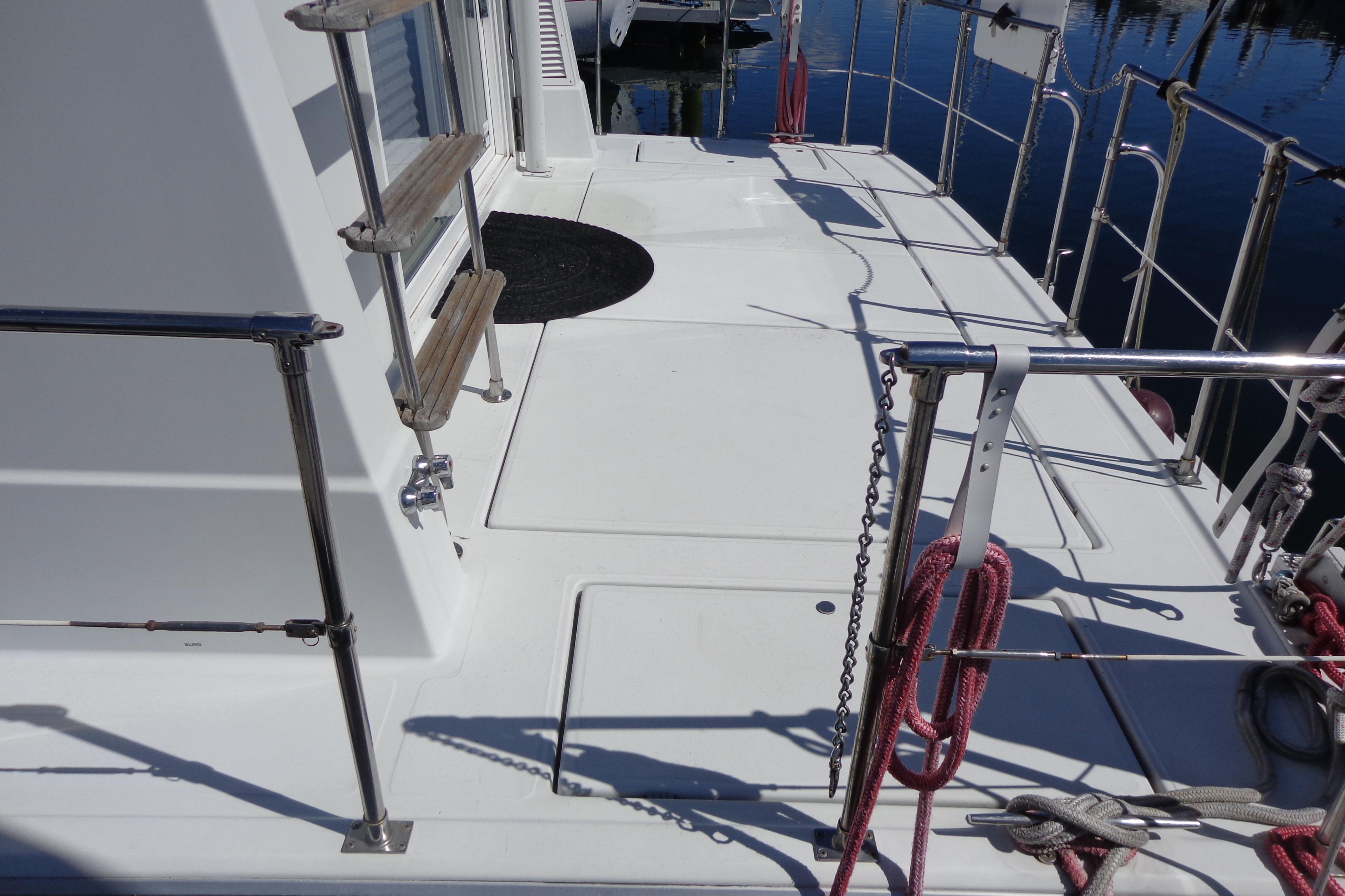 1992 Cruise-A-Home Corsair 4200 deck with railing and ladder, docked by water.