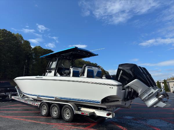 2024 Fountain 34 SC boat on trailer under blue sky.