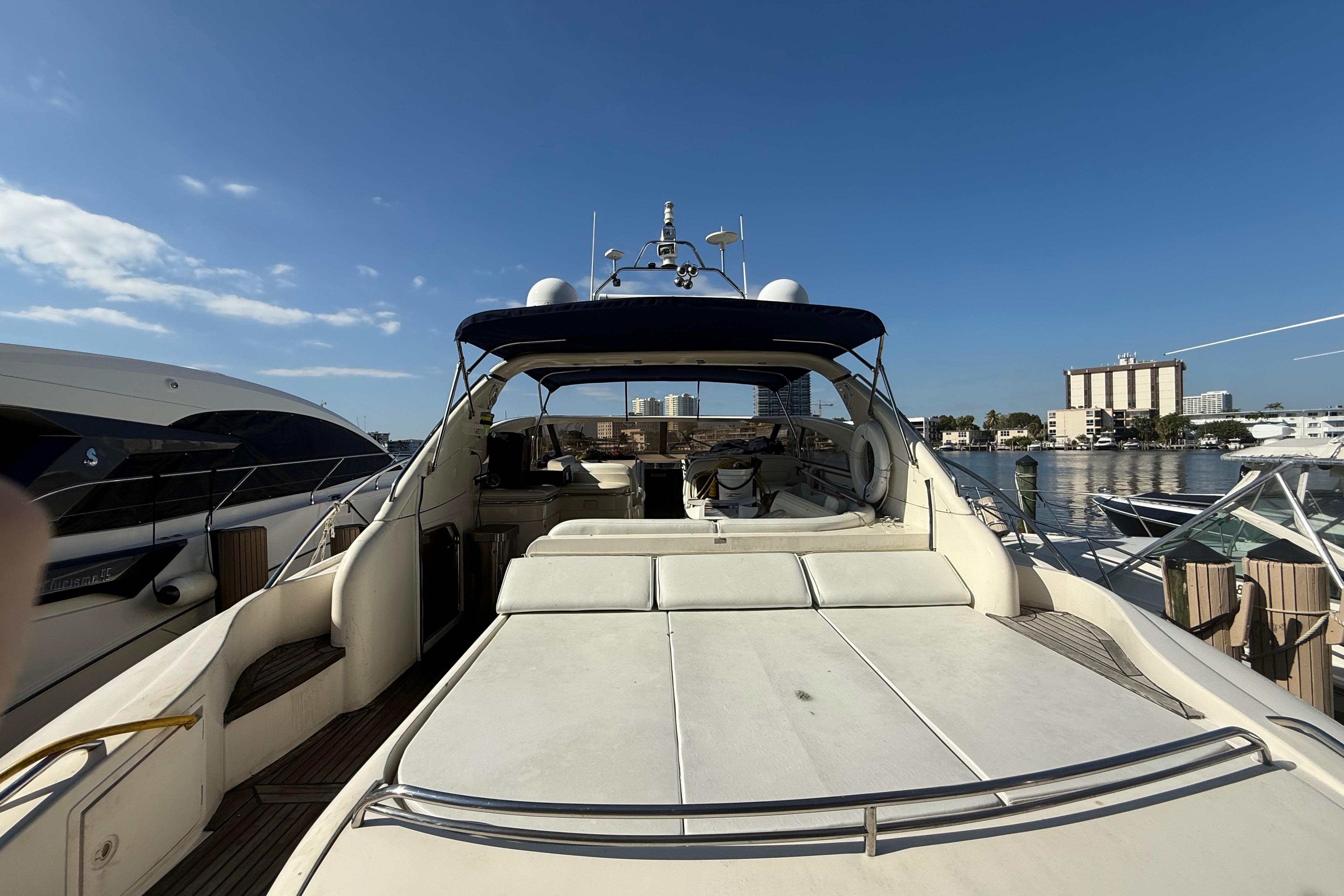 2002 Viking Princess V50 yacht docked at marina under clear blue sky.
