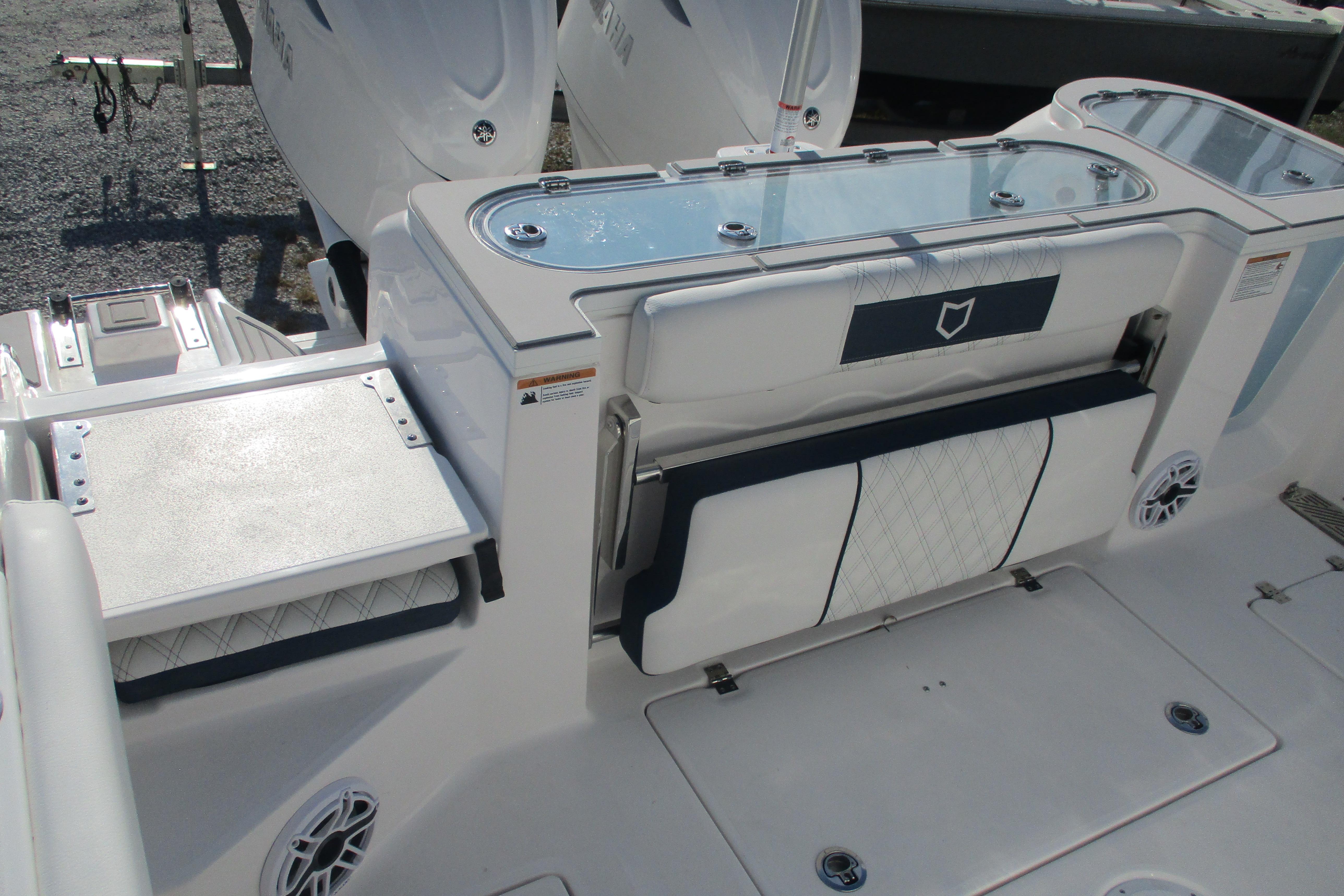 2026 Sea Fox 328 Commander boat deck with seating and storage features.
