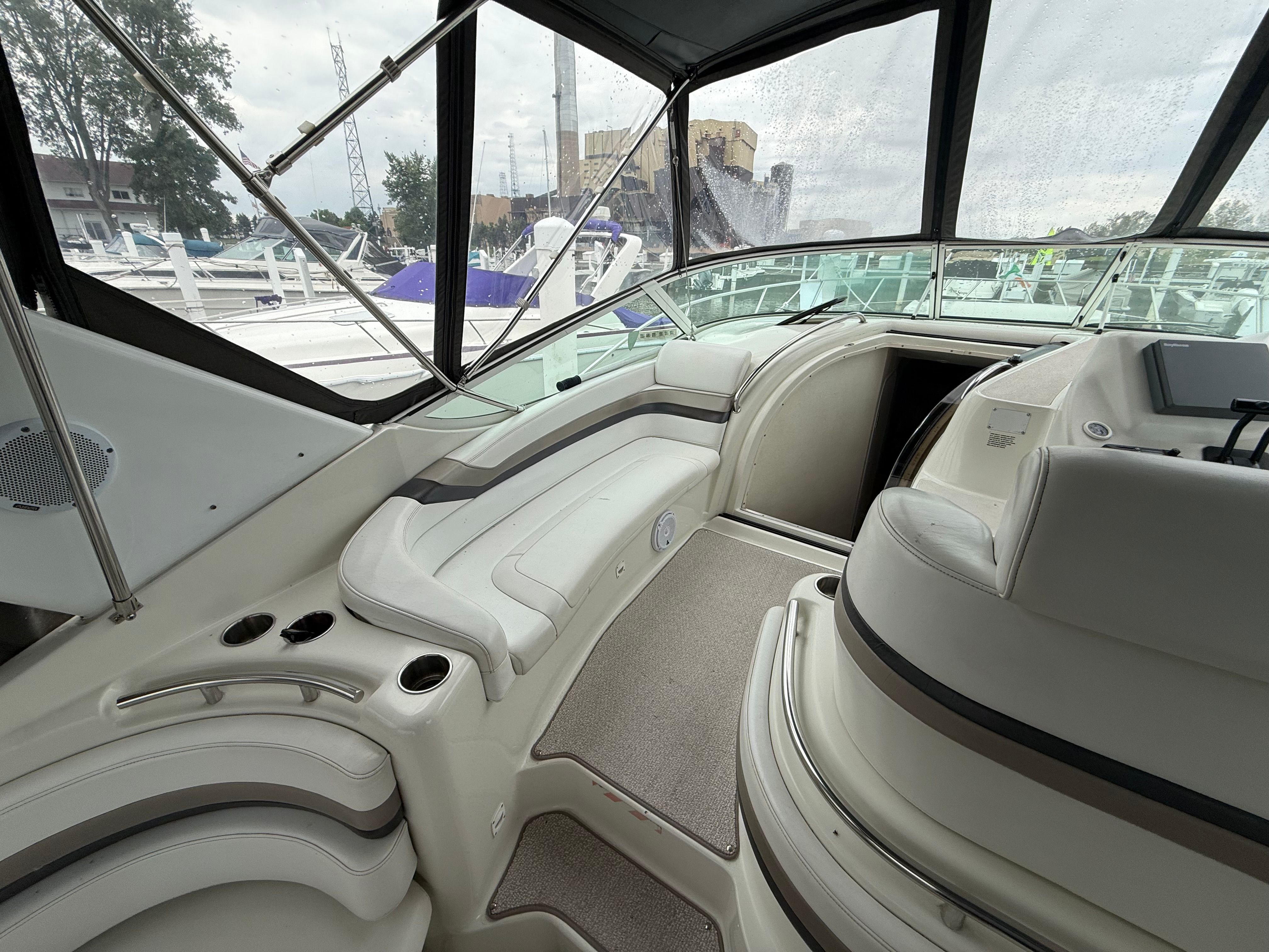 Interior of a 1995 Silverton 360 with white seating and helm station.