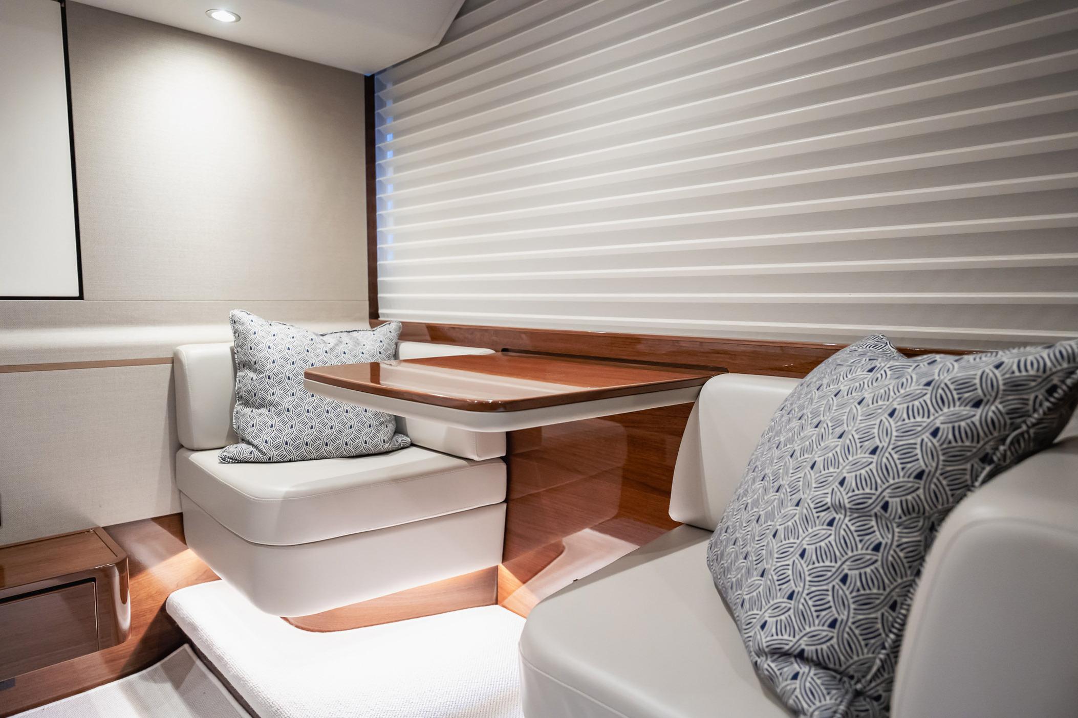 Luxurious interior of 2019 Princess F55 yacht with elegant seating and cushions.
