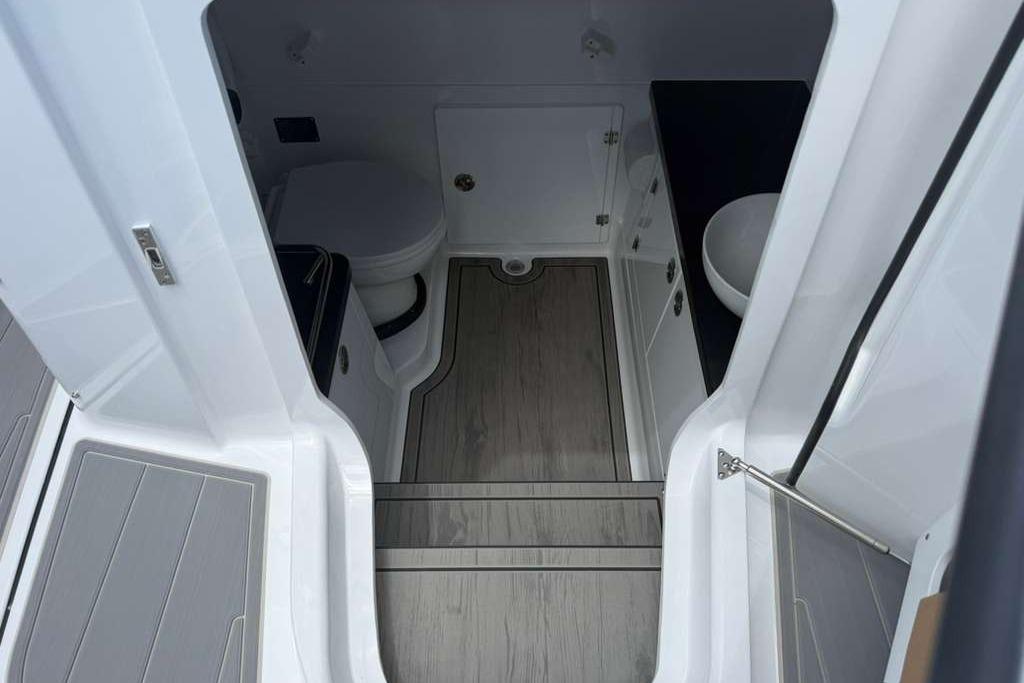 Interior of 2026 Monterey Elite 30 OB boat, featuring modern bathroom amenities.