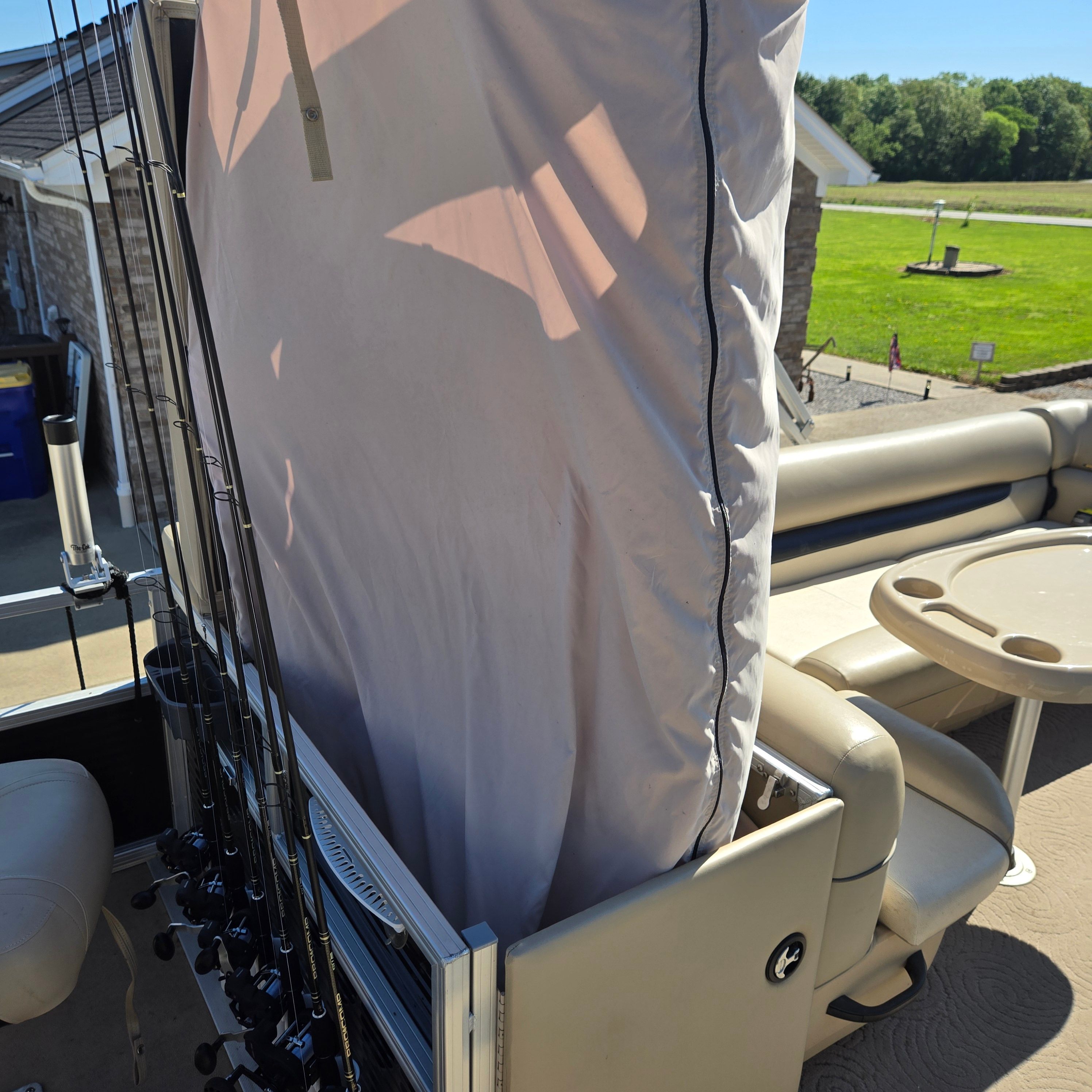 Fishing rod holders and seating area on a pontoon boat.