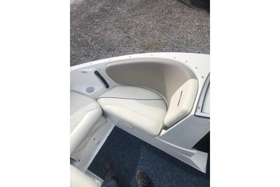 2012 Sea-Doo 180 Challenger boat interior with white seating and blue carpet.