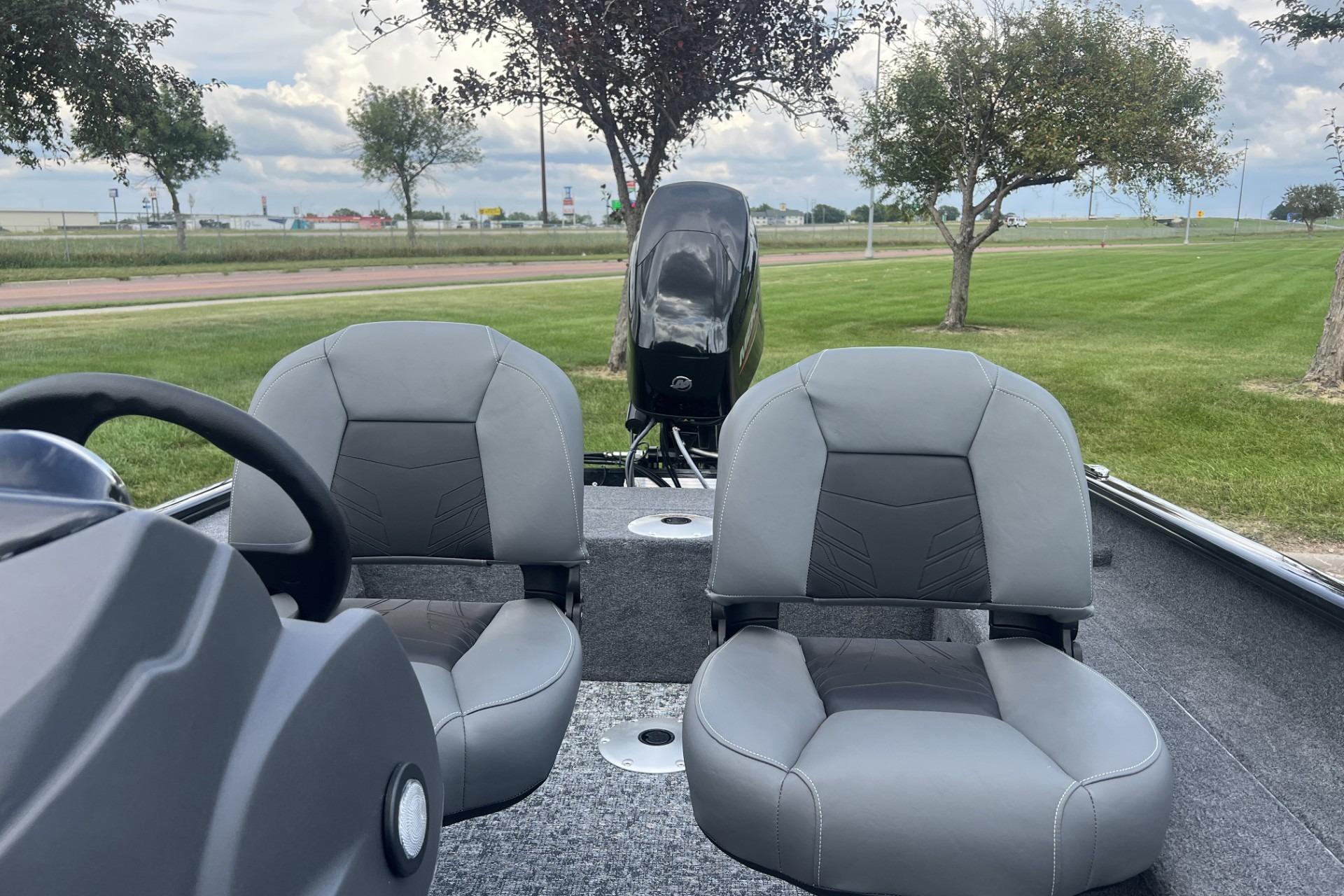 2026 Tracker Super Guide V-16 SC boat interior with two gray seats and steering wheel.