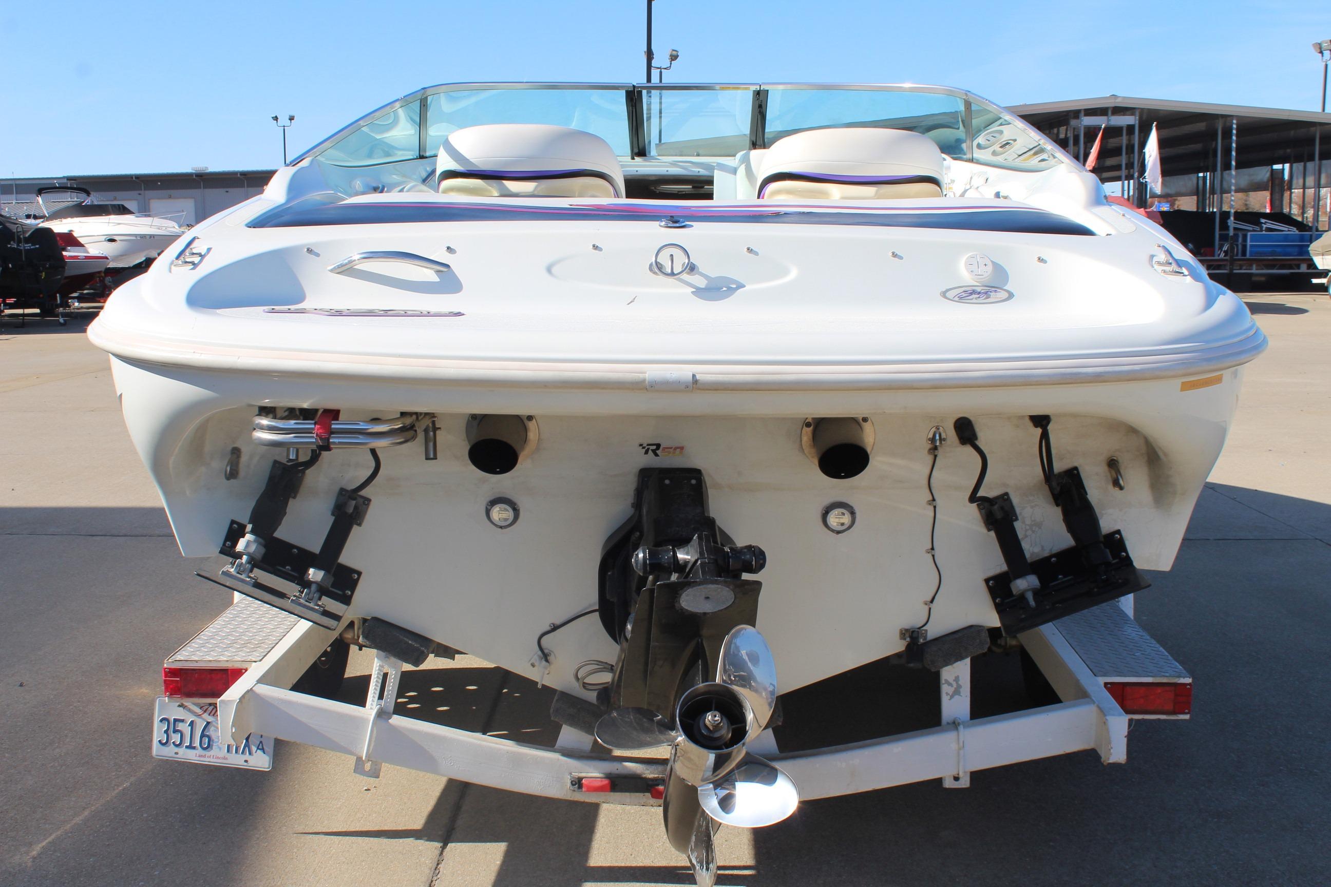 1996 Baja 232 boat rear view on trailer, showcasing engine and propeller.