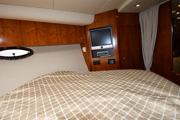 Interior cabin of 2010 Cruisers Yachts 390 Sports Coupe with TV and bed.