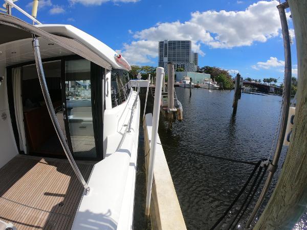 2017 Jeanneau NC 11 docked at a marina on a sunny day.