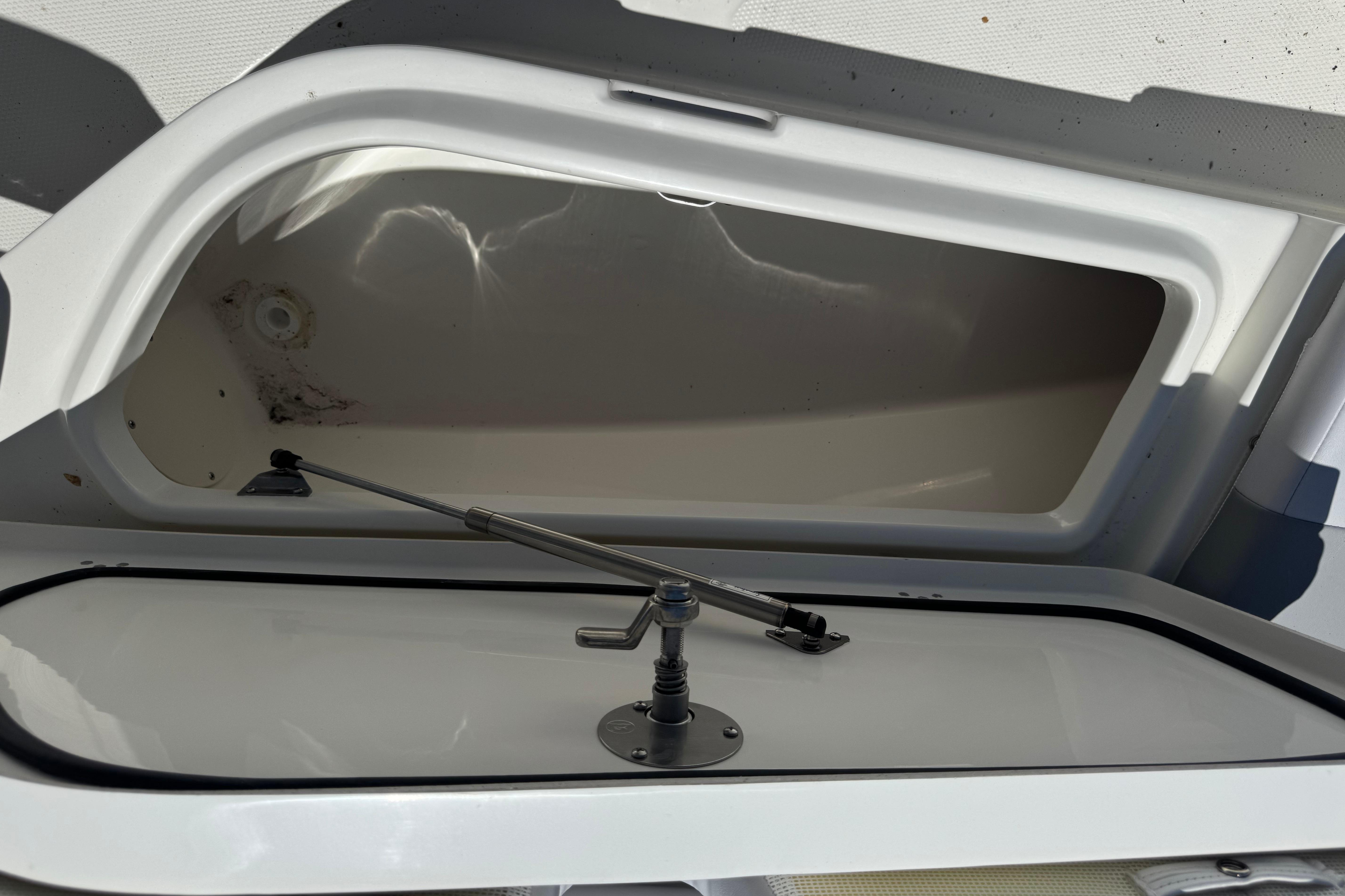 Open storage compartment on 2026 Mako 214 Center Console boat.