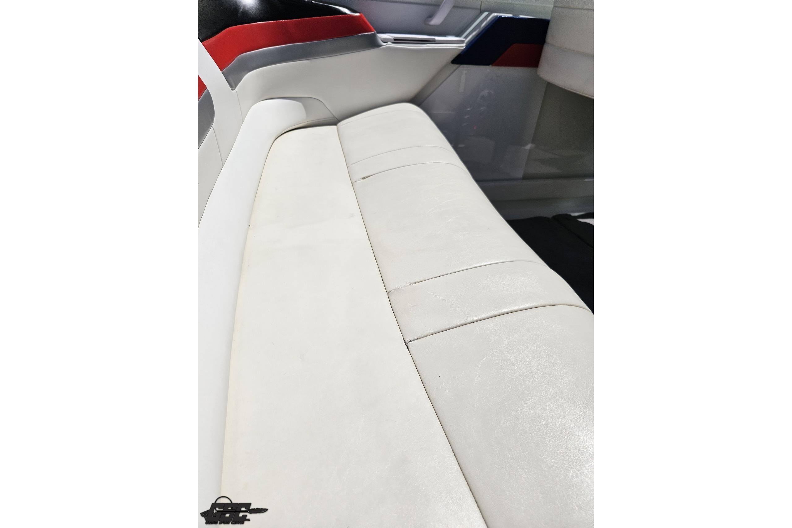 2005 Formula 271 FASTech boat interior with white leather seating and red accents.