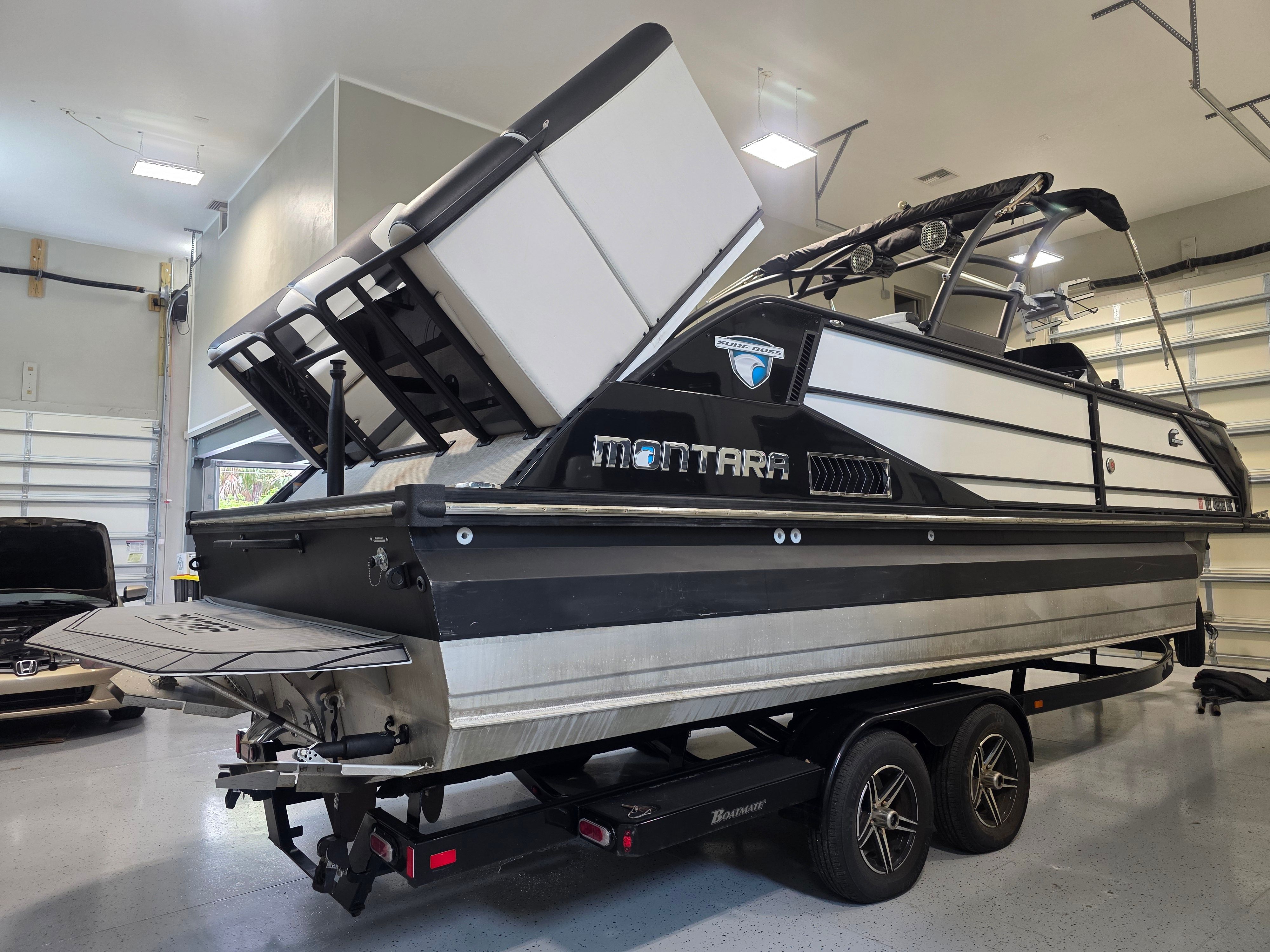 2021 Montara SURF BOSS 25 boat in garage on trailer.