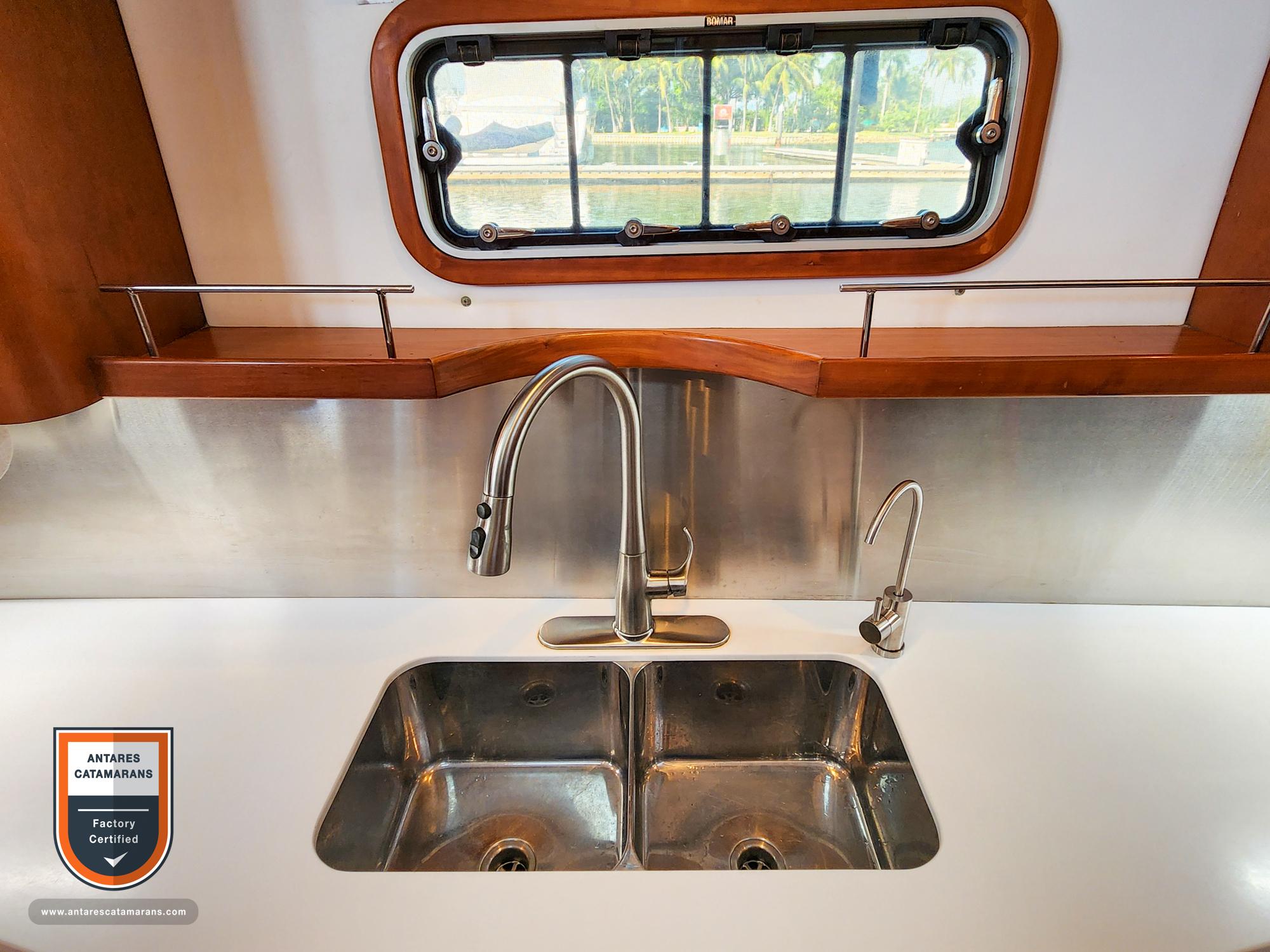 Modern kitchen sink on 2019 Antares 44 GT yacht with window view.