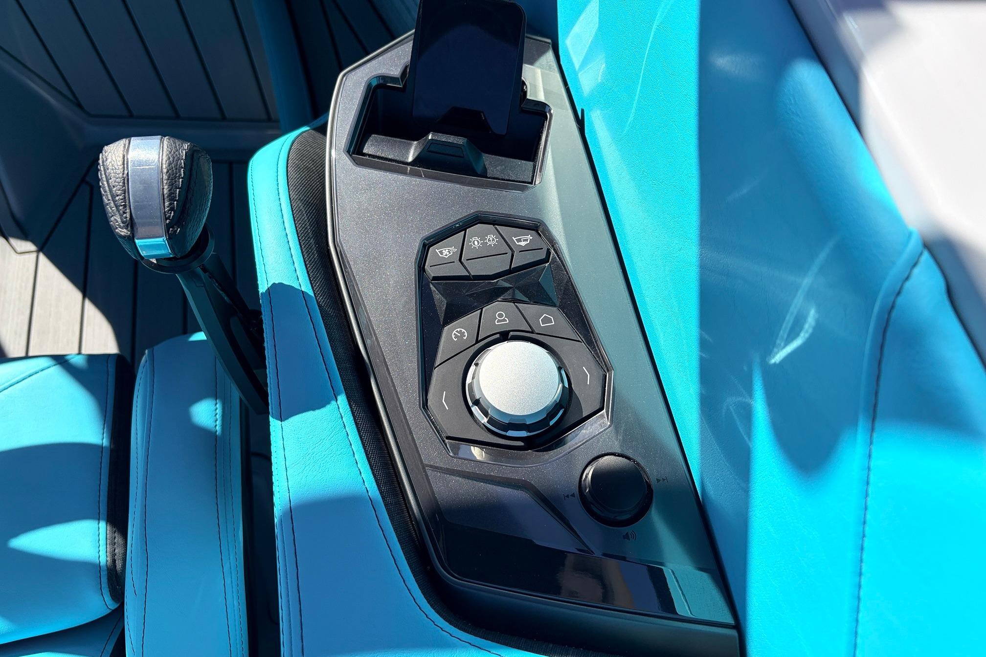 Control panel of 2026 Nautique Super Air Nautique G23 with sleek design and vibrant blue upholstery.