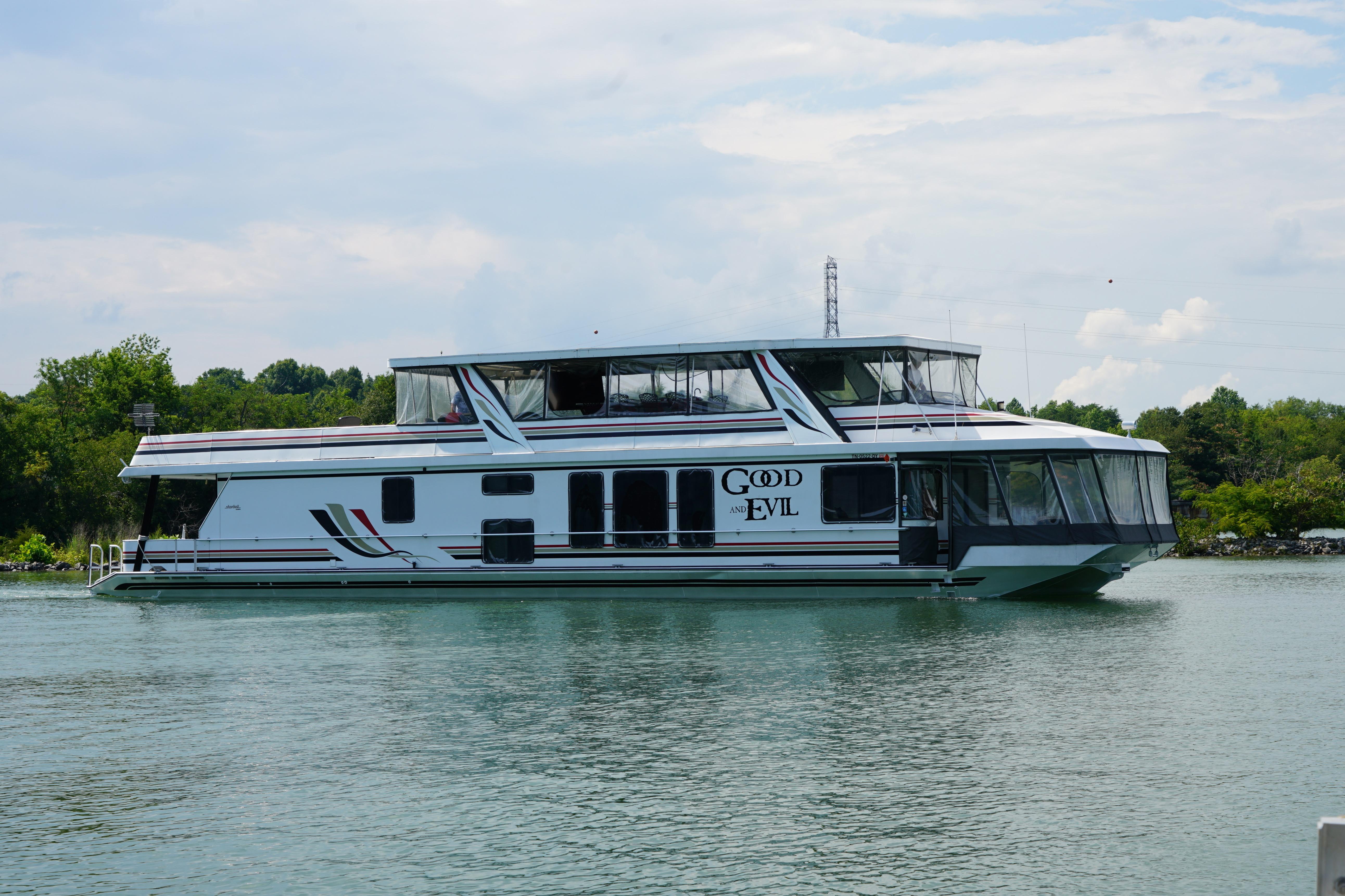 Houseboat on a lake, Stardust Cruisers 83'x17', year 2000, named "Good and Evil".