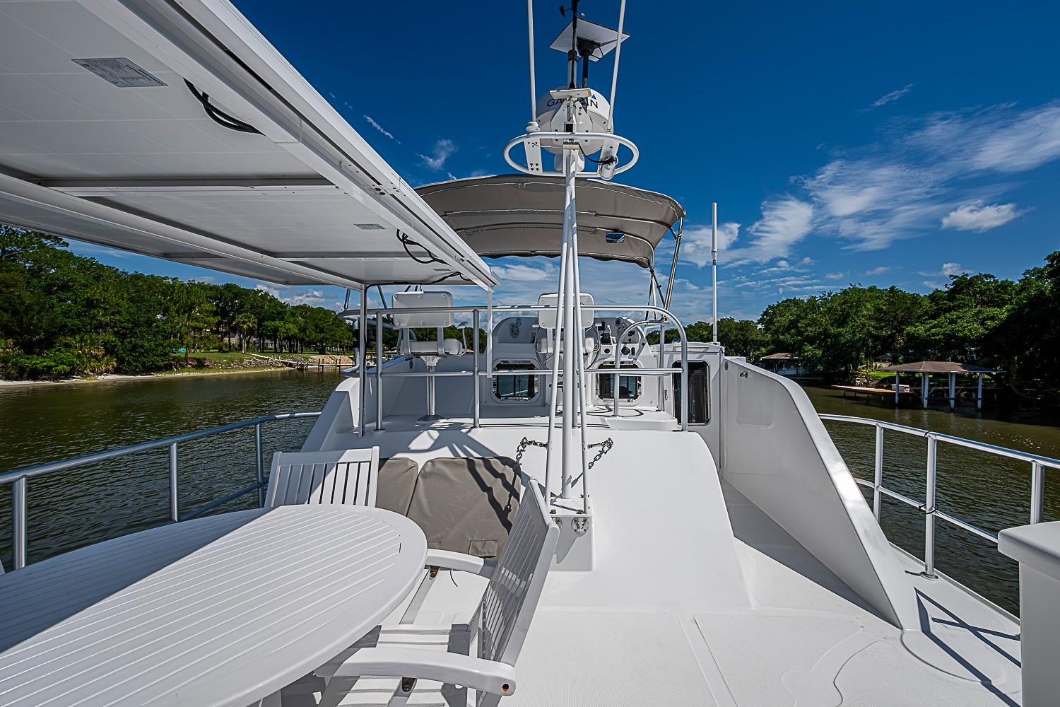 2003 Magna Marine Nova Scotia 47 yacht deck with seating, under clear blue skies.