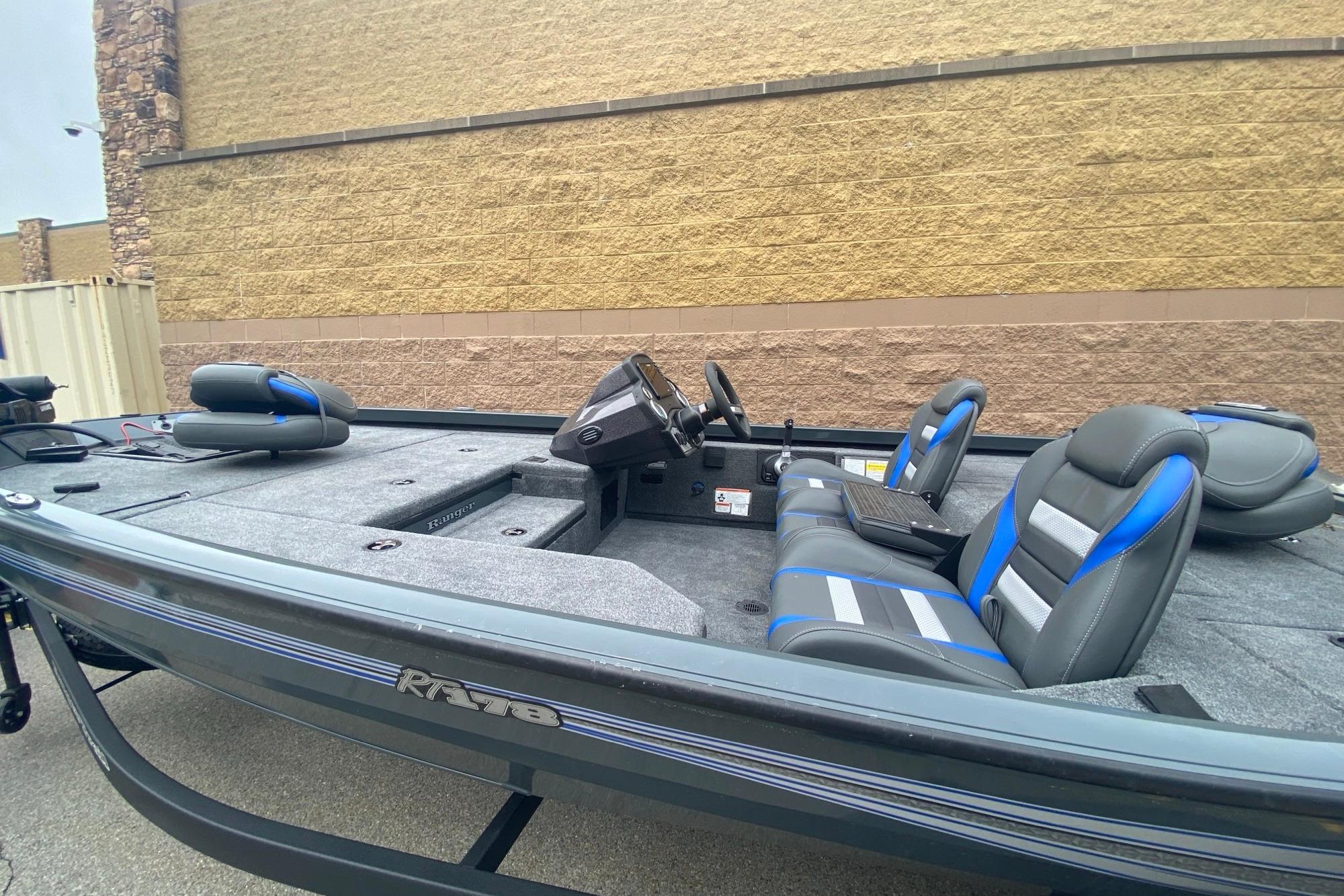 2026 Ranger RT178 boat with blue and gray seating, parked outdoors.