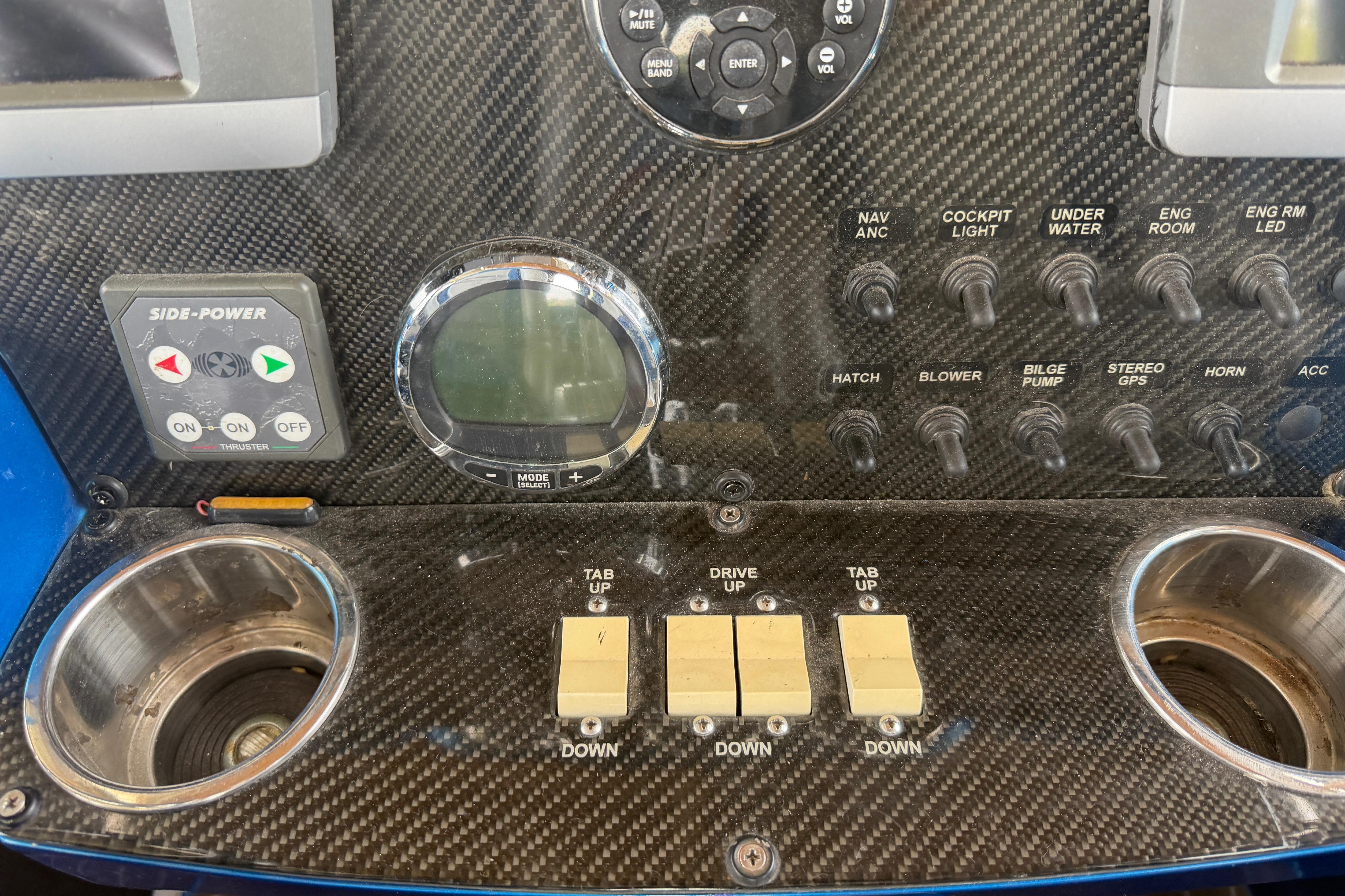 Control panel of a 2013 Nor-Tech 477 SPX Vee Bottom boat with switches and gauges.
