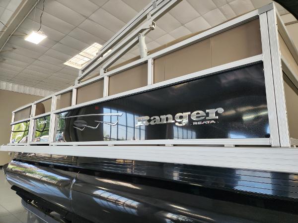 2025 Ranger 200C pontoon boat displayed indoors, showcasing sleek design and branding.